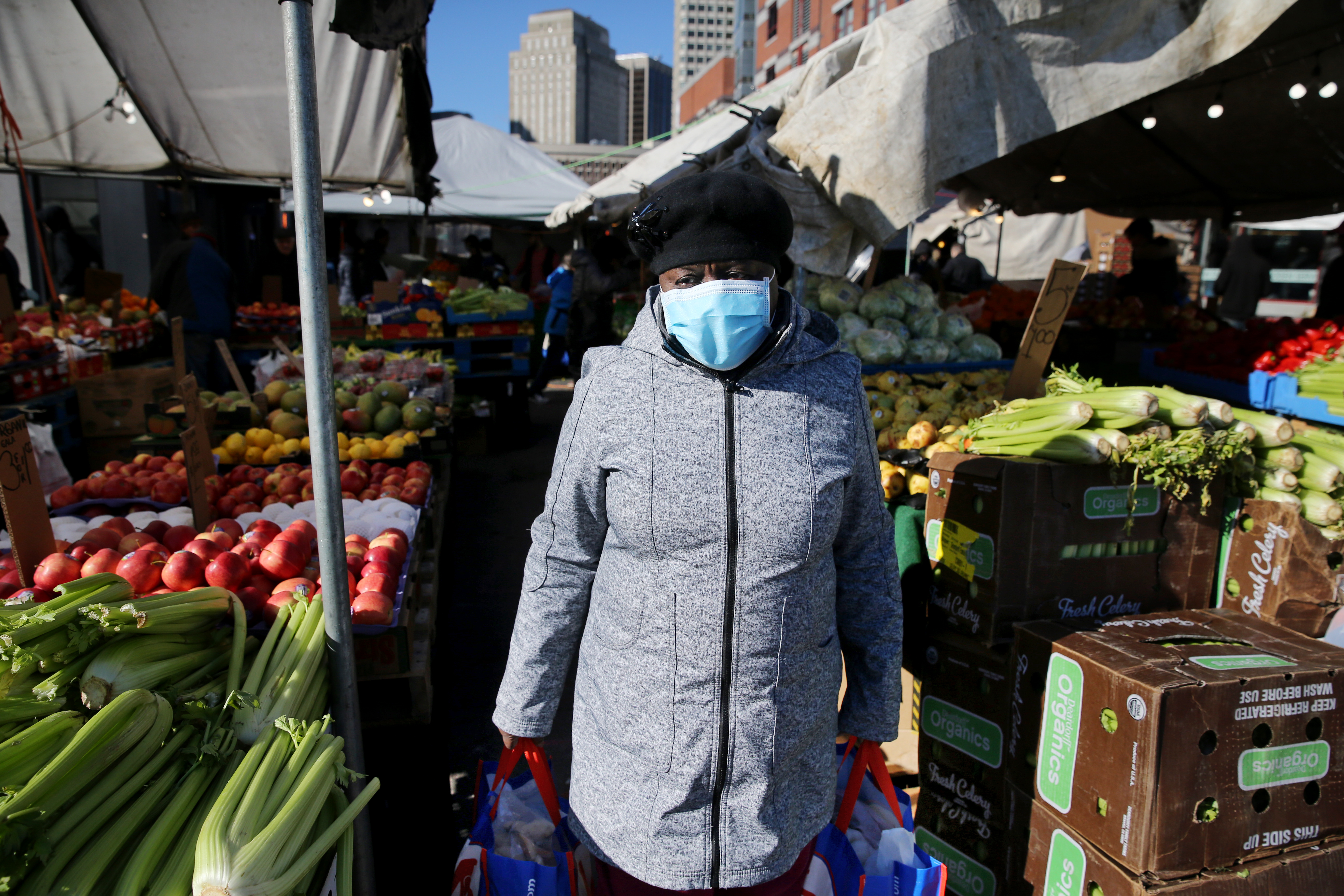 A woman shops for produce at Haymarket in March.