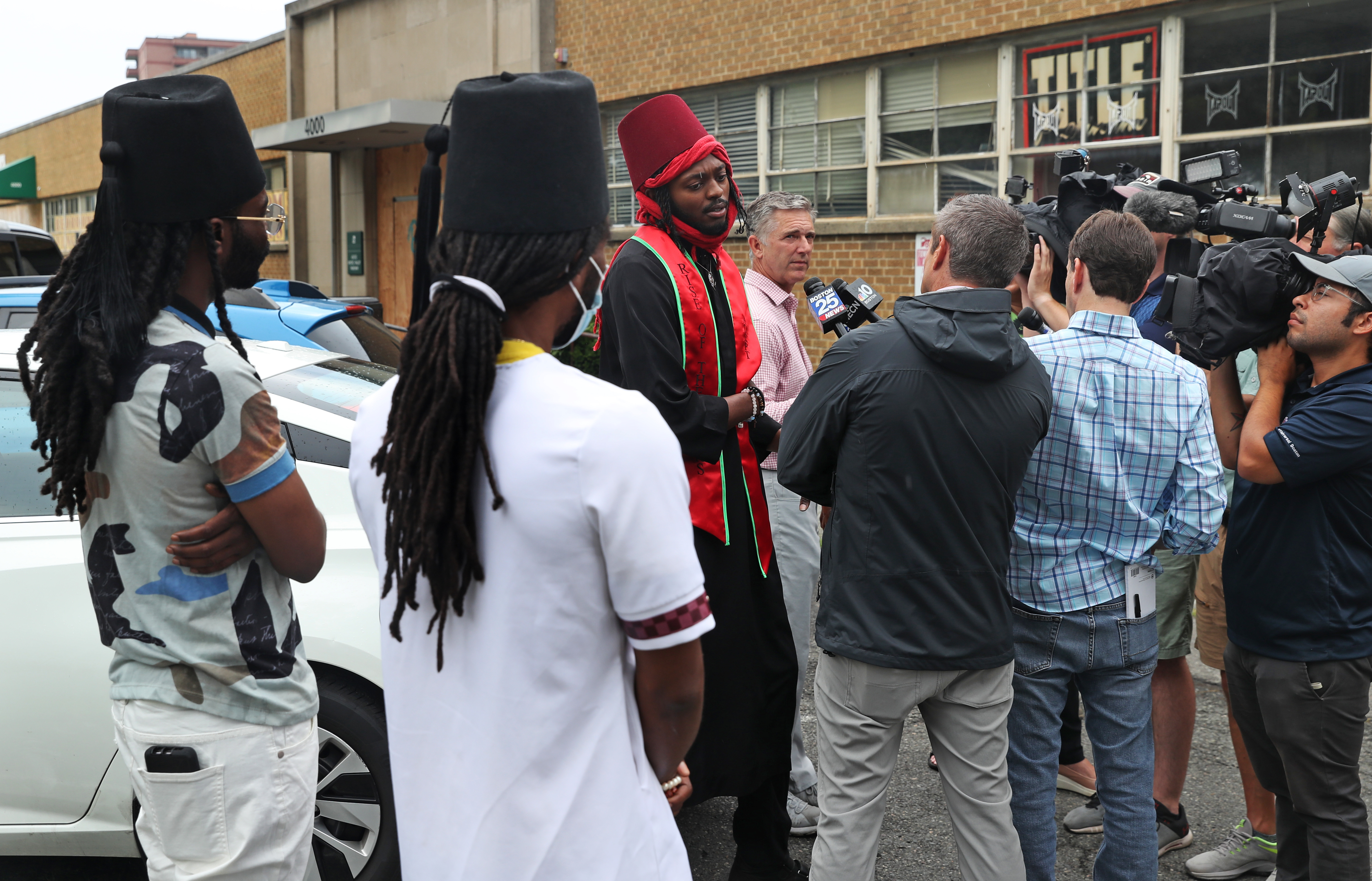 Rashad Bey (center) of Philadelphia, spoke with the media outside the Malden District Court as two other members of his Moorish group looked on.