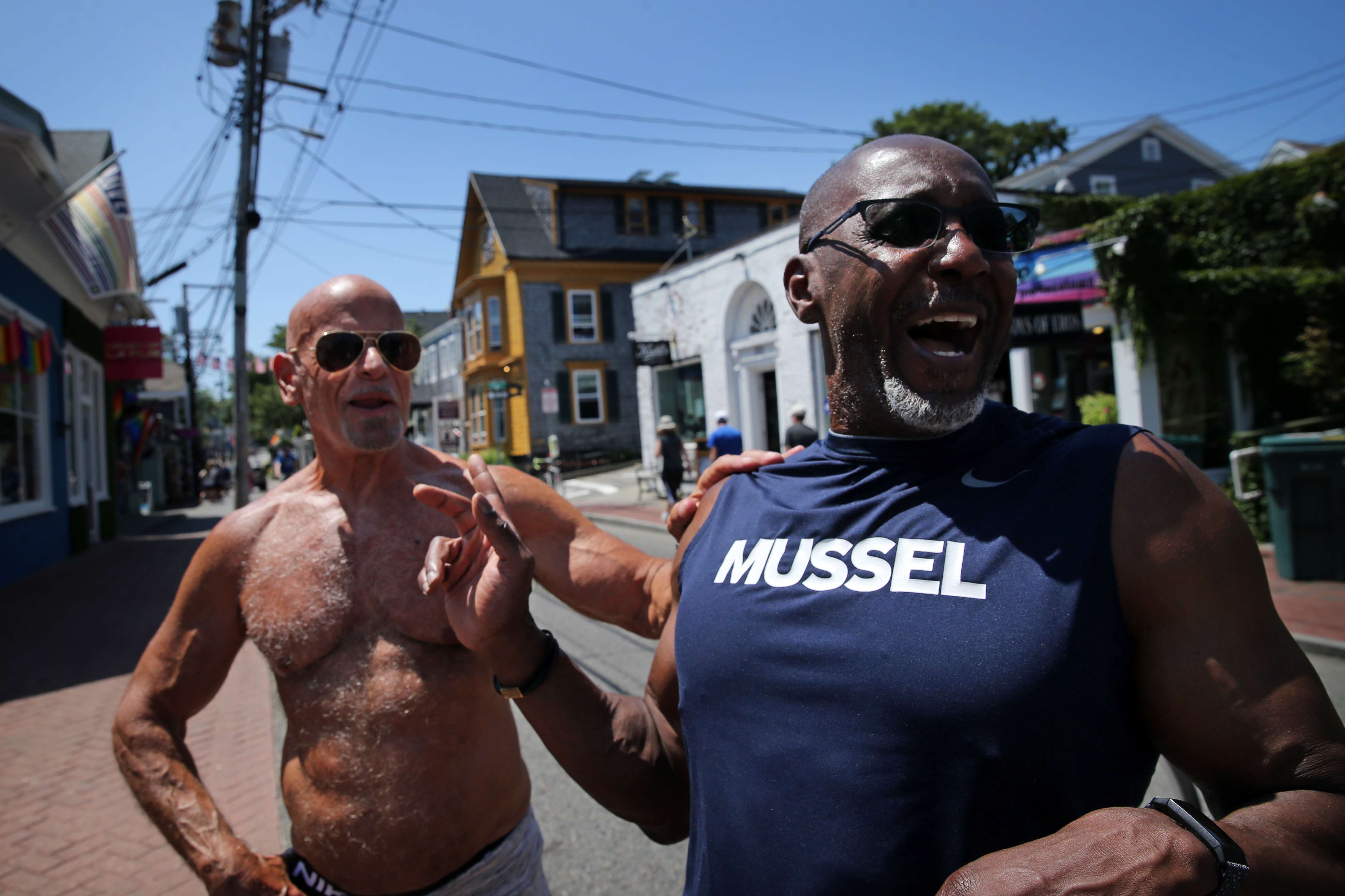 Jeff Lavine, left, and his husband Skip Sherald of Doylestown, Penn., shared a laugh on Commercial Street in Provincetown. “It’s not just Provincetown, it’s everywhere,” Lavine said about COVID-19.