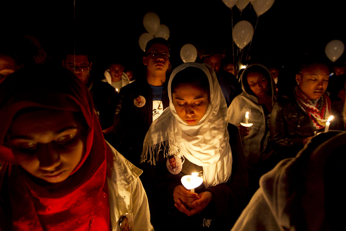 Arusa Zama (left) and her sister Sumaiya, friends of the Henry family, prayed at the start of a vigil in 2011. Twelve Chinese Lanterns were lit and released into the sky as well as balloons.
