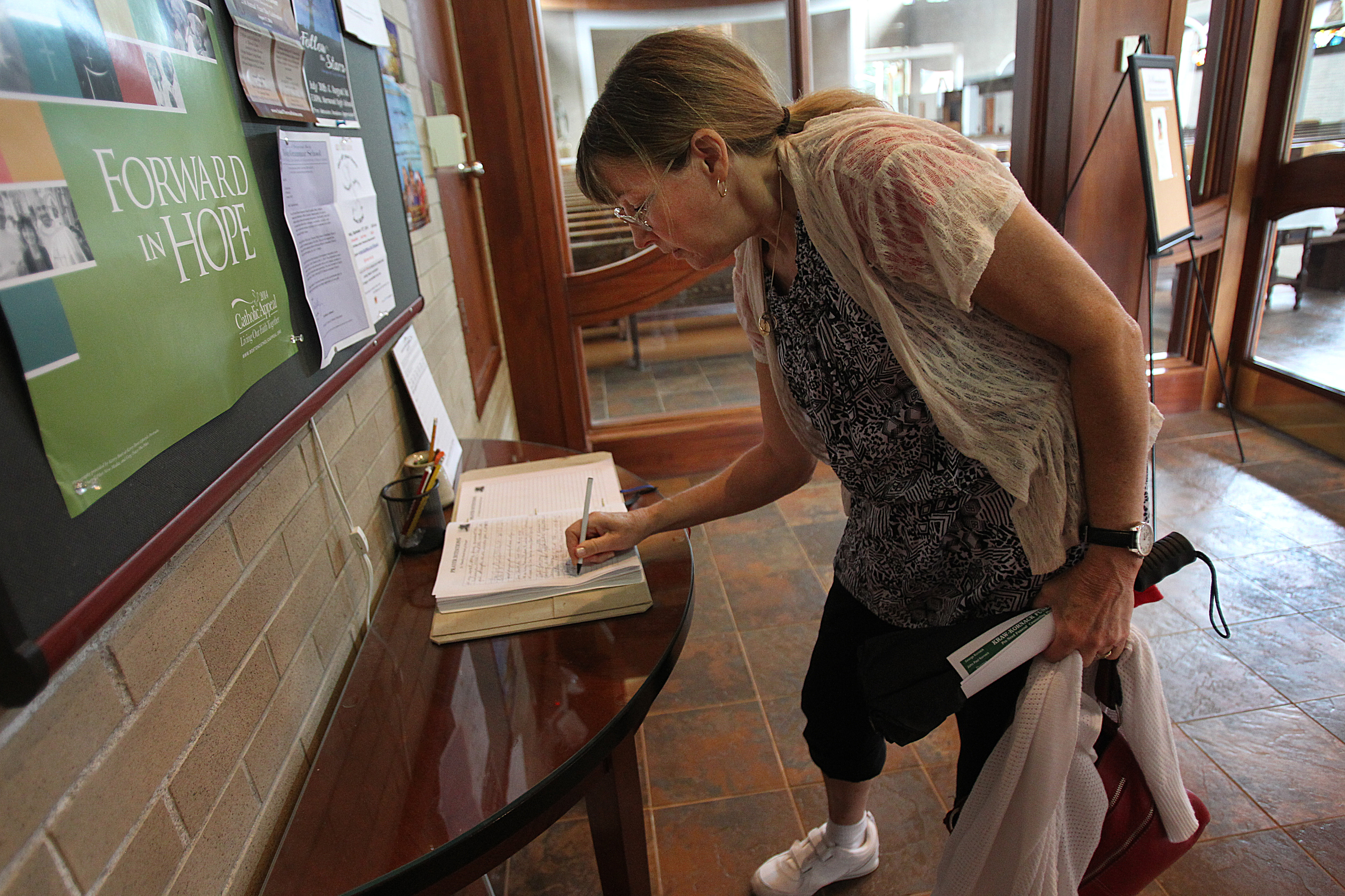 Peggy signed the prayer book at St. Timothy’s Catholic Church. She often turned to her faith as she struggled with Mike’s illness.