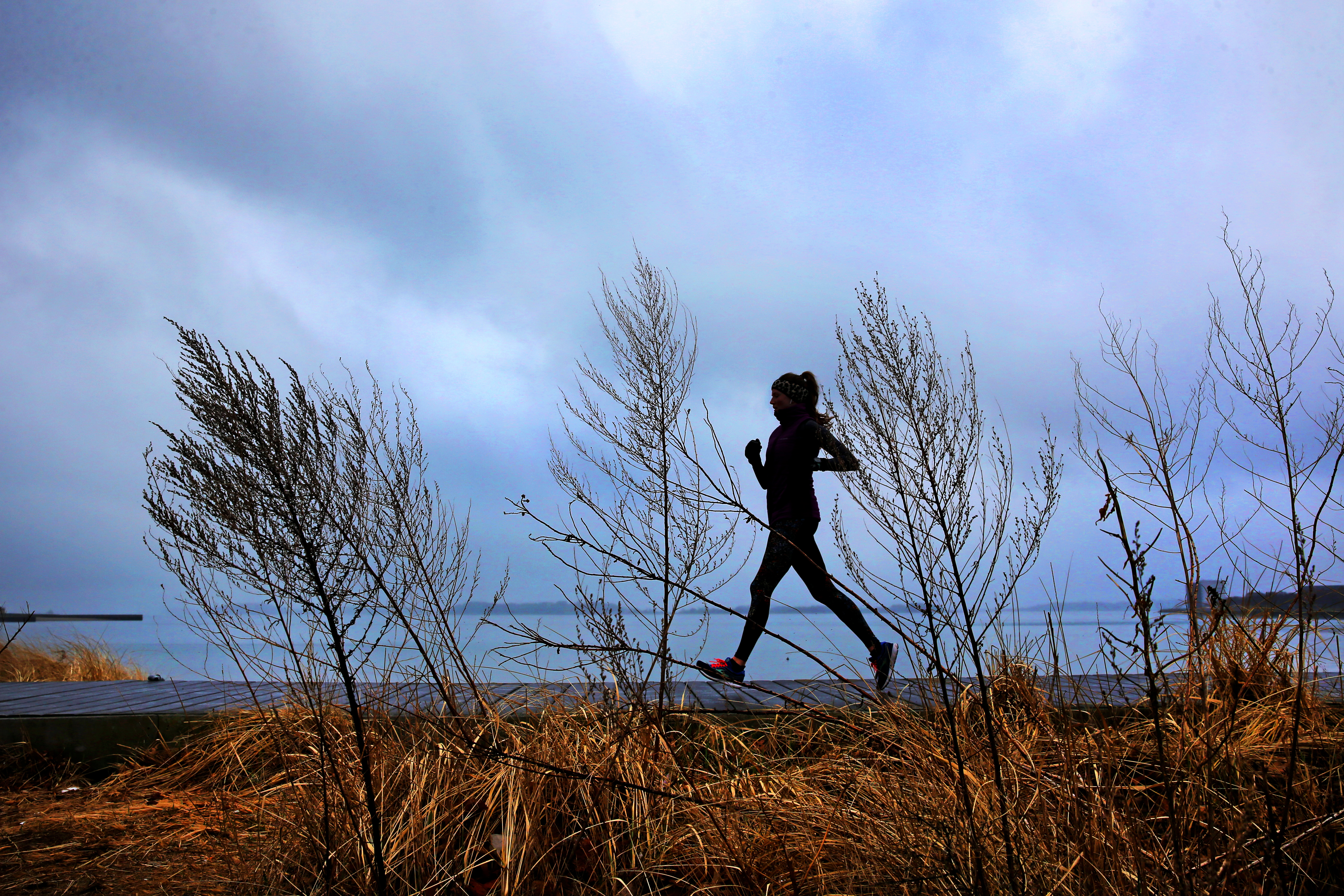 A woman enjoyed a brisk run along the coast in South Boston on March 17.