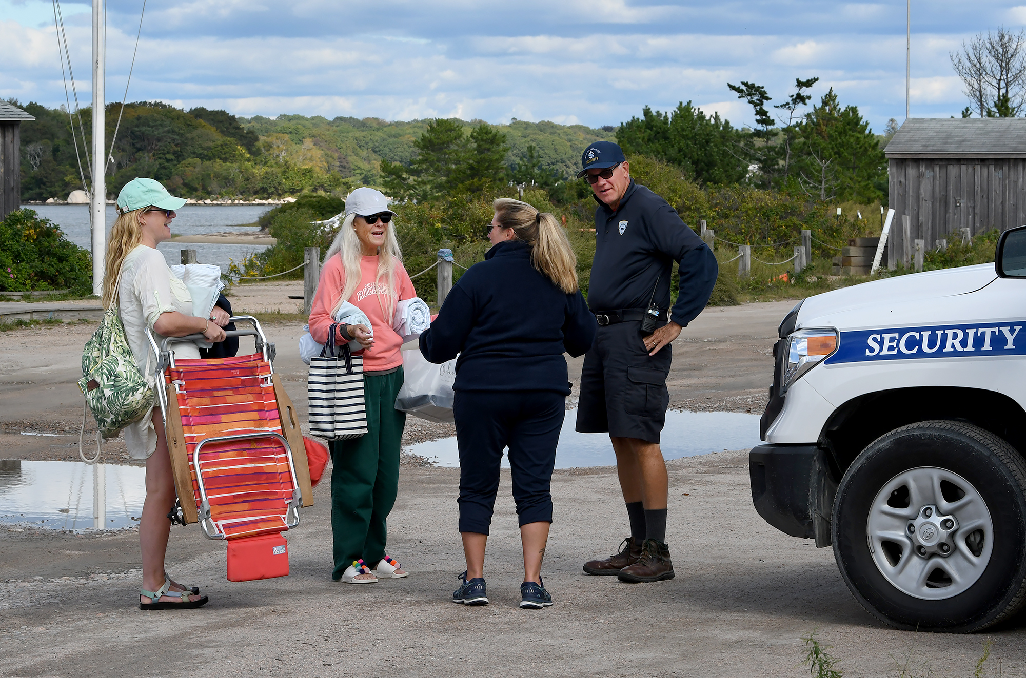A Weekapaug Fire District security officer speaks with residents of Weekapaug. Although access to the beaches are permitted to the public after September they are not accessible during the summer season.