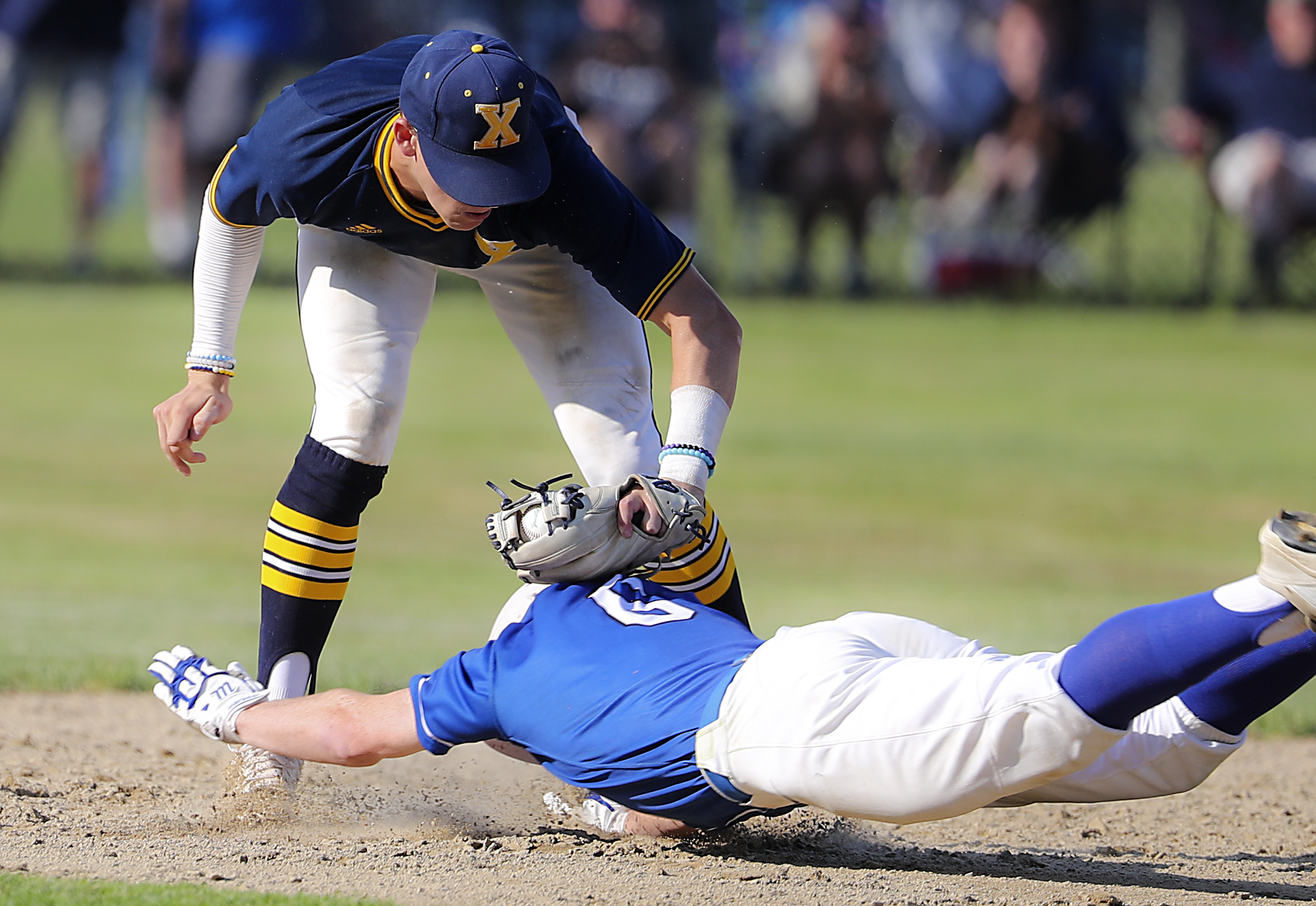 Xaverian second baseman Henry Fleckner tags out Leominster's Eamon Durkan to record the final out as Xaverian defeats Leominster for the Division 1 state.