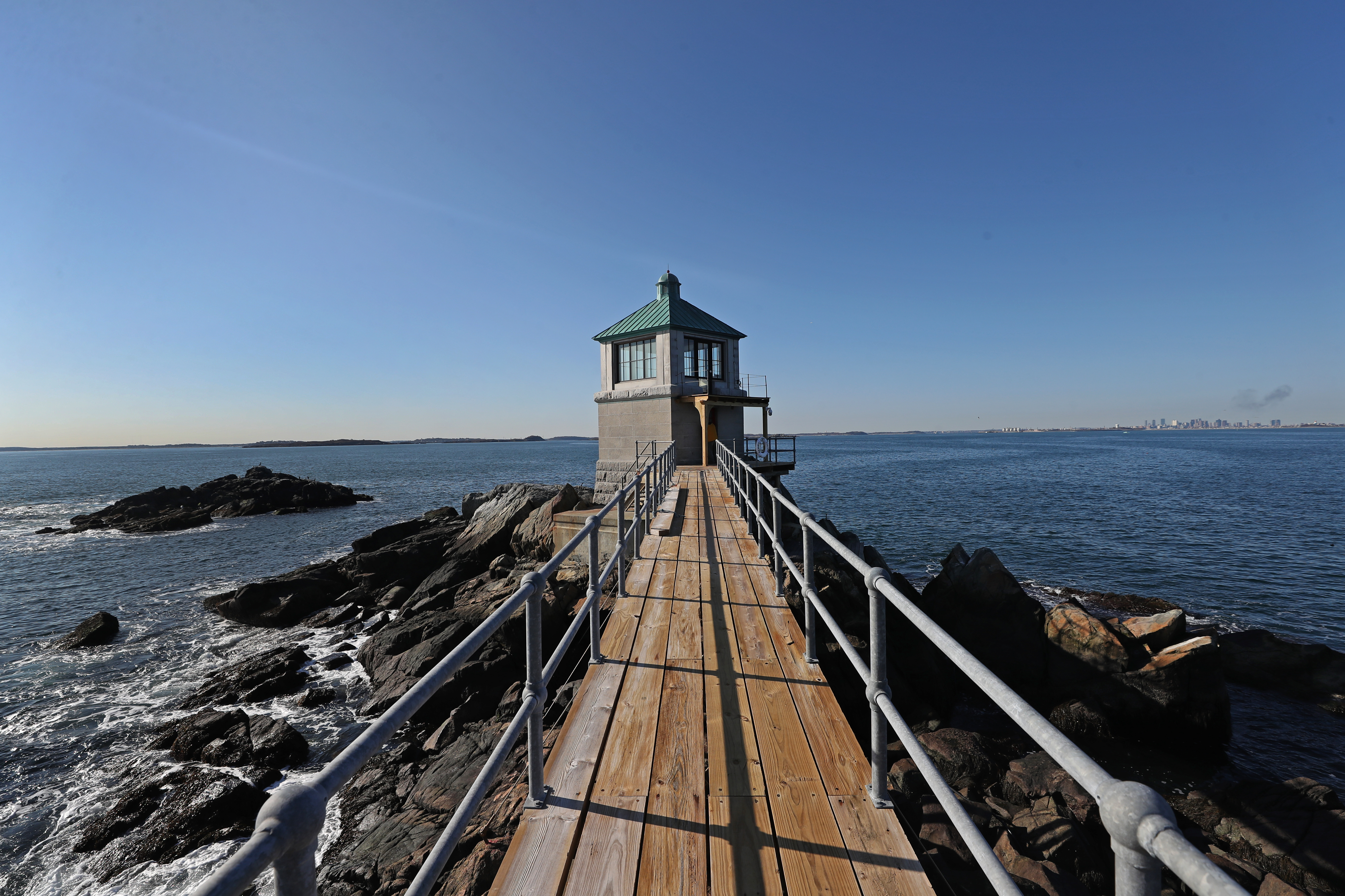 A view of Boston from afar from the restored walkway and oil house at Graves Light.