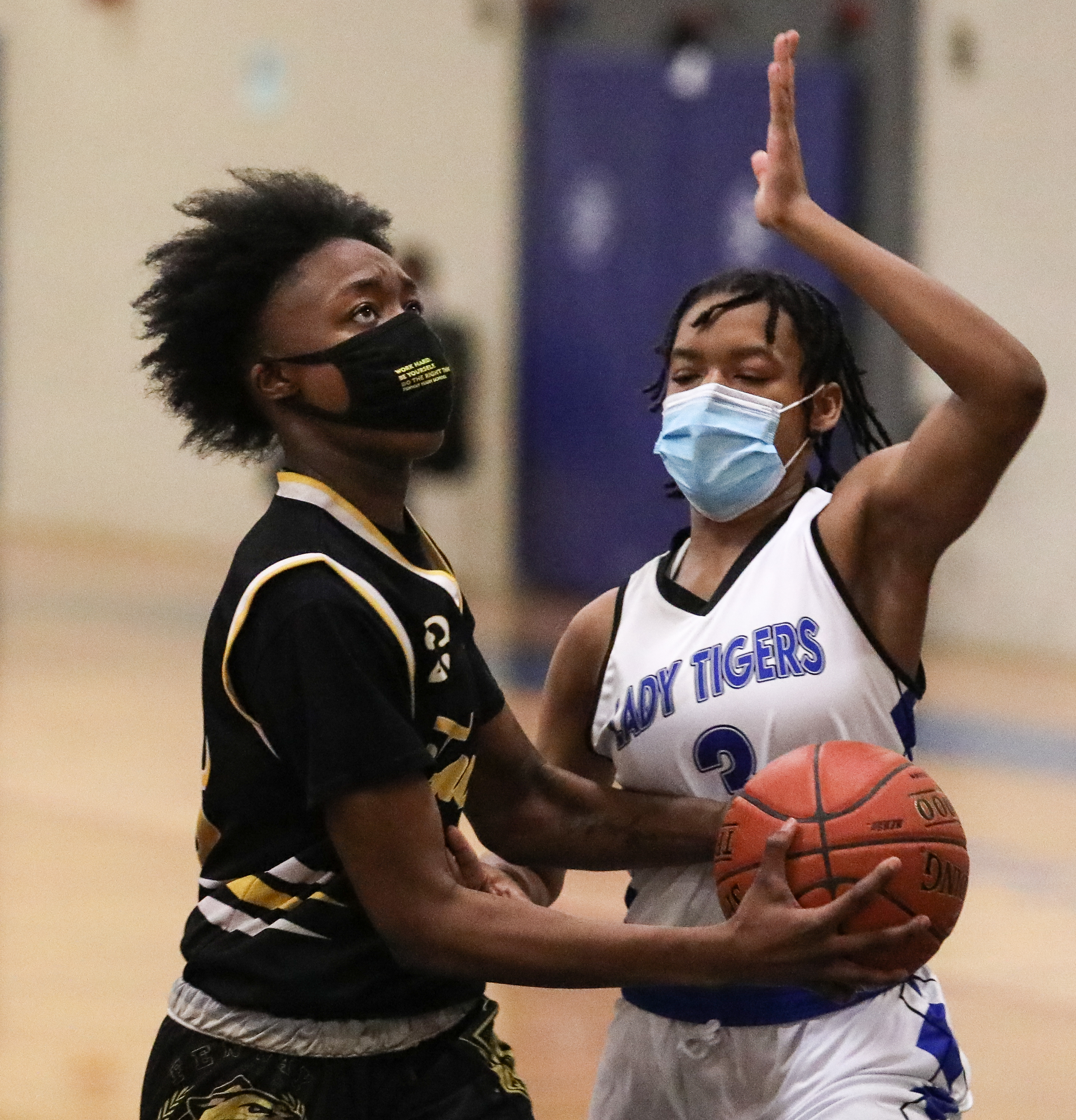 Fenway’s Kayana Armbrister (24) eyes the hoop while being guarded by O’Bryant’s Jasmine Cox.