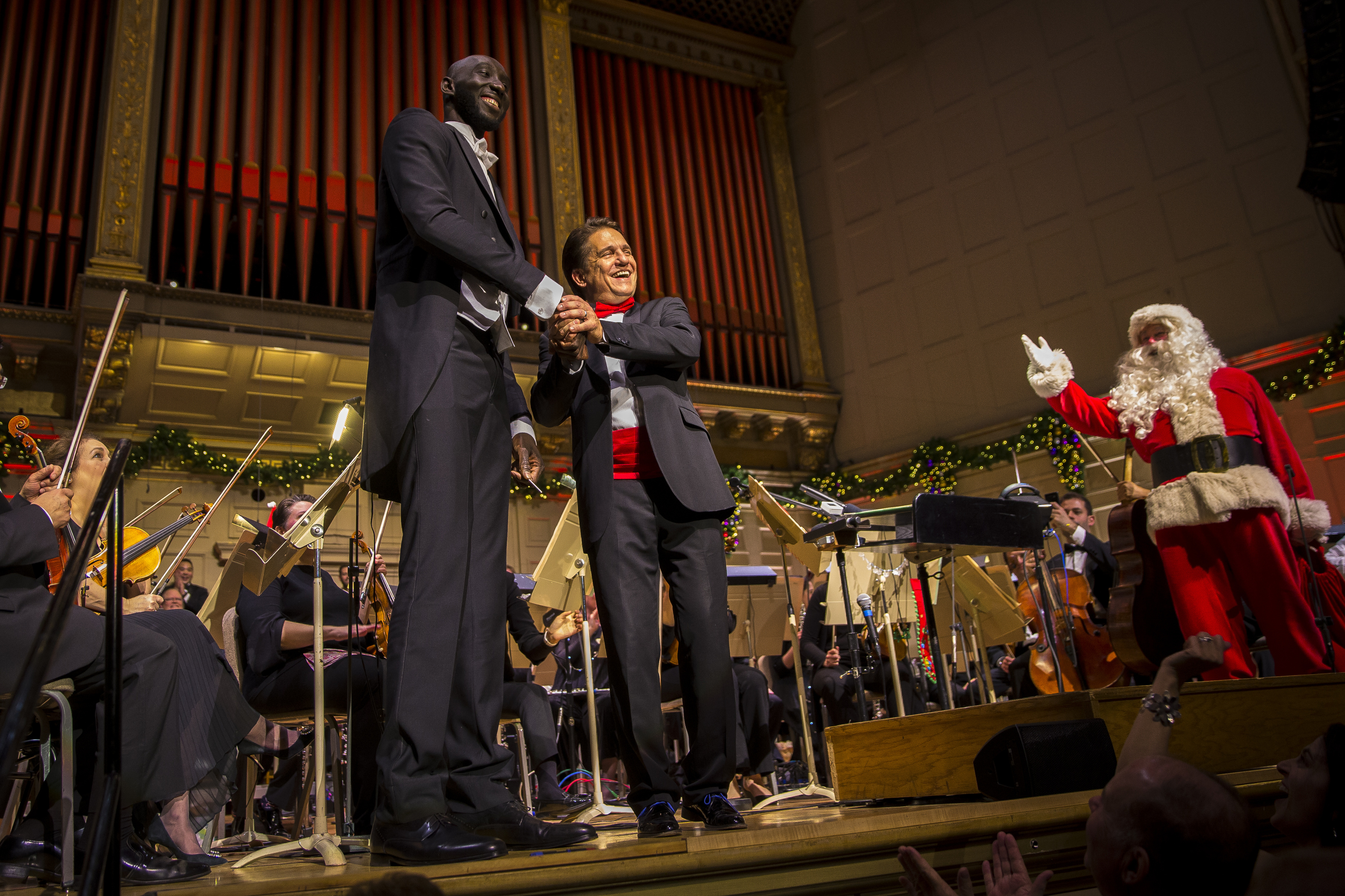 Boston Celtics center Tacko Fall was welcomed on stage by Keith Lockhart to conduct “Sleigh Ride” at Symphony Hall on Dec. 23.