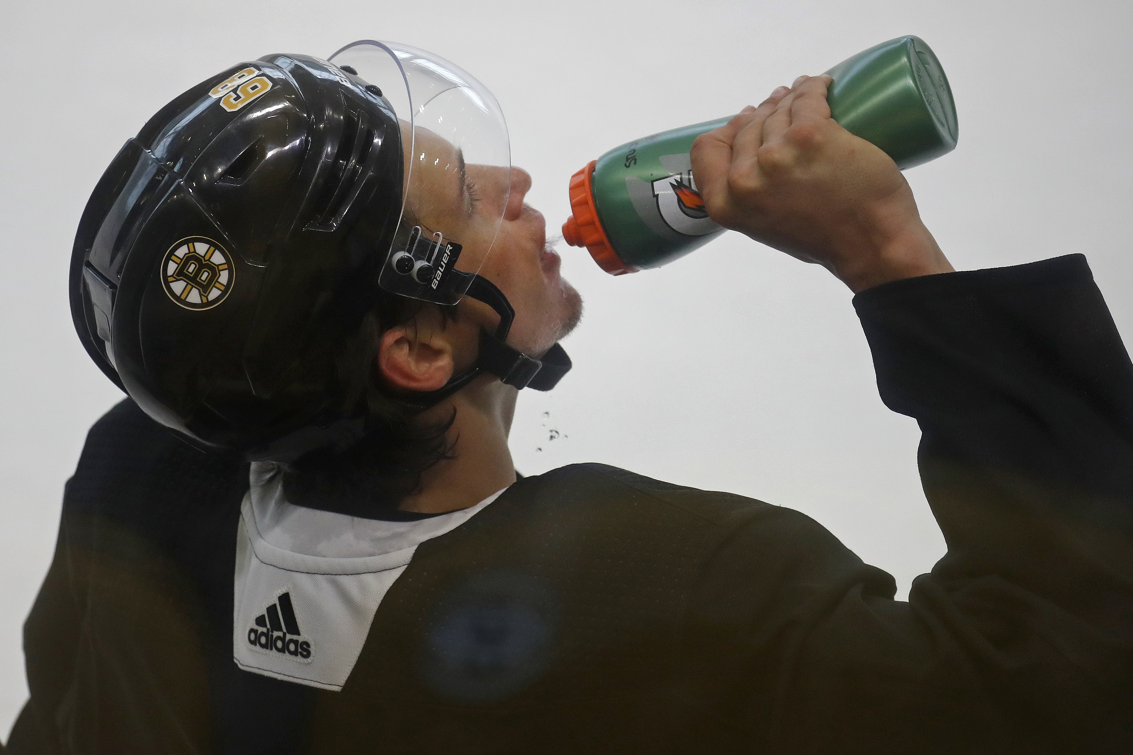 Jack Studnicka takes a break for a drink during a recent Bruins' practice.