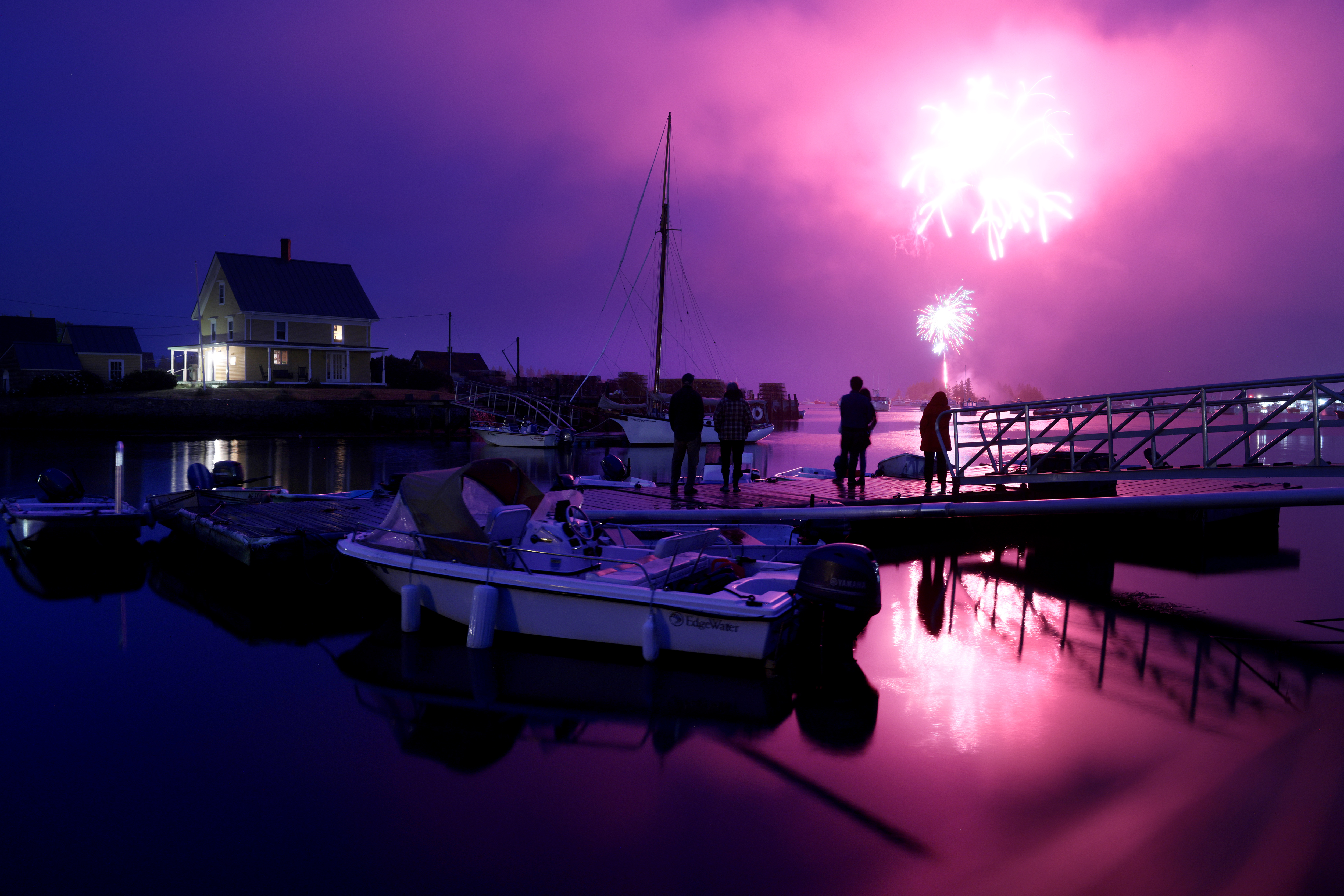 People ventured out onto a dock to take in the Fourth of July fireworks as they exploded over Carvers Harbor in Vinalhaven.
