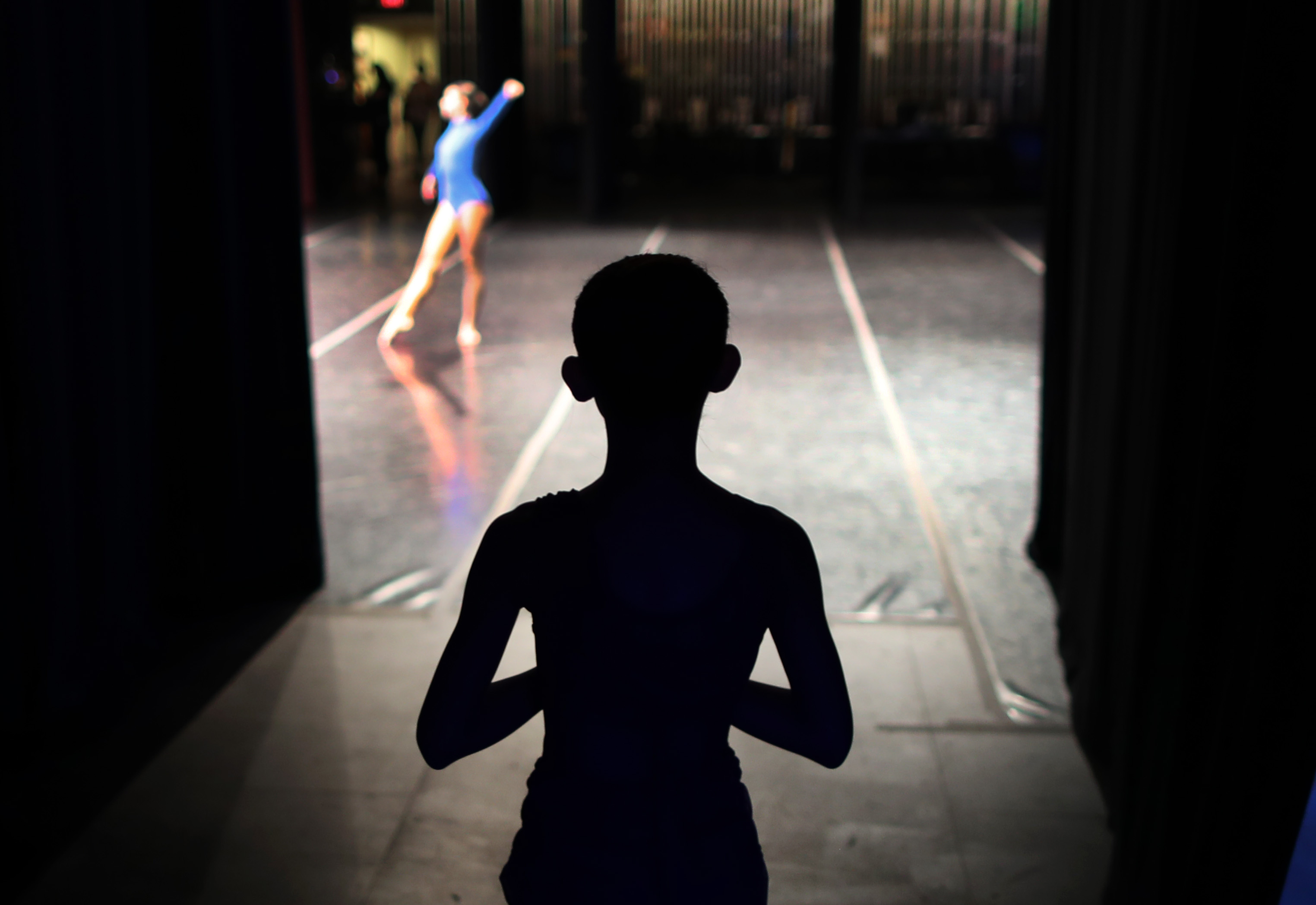 A dancer waited her turn as she watched from off stage.