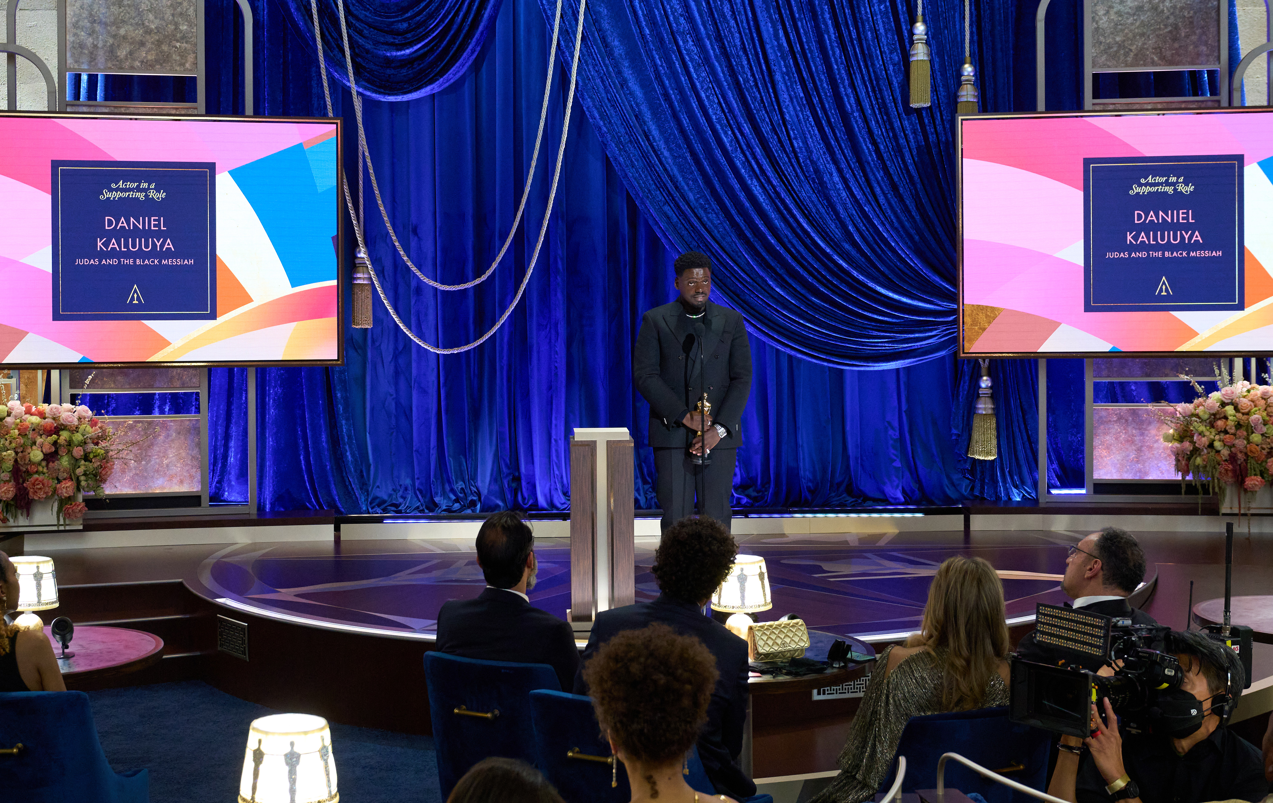 Daniel Kaluuya accepts the Academy Award for best supporting actor.