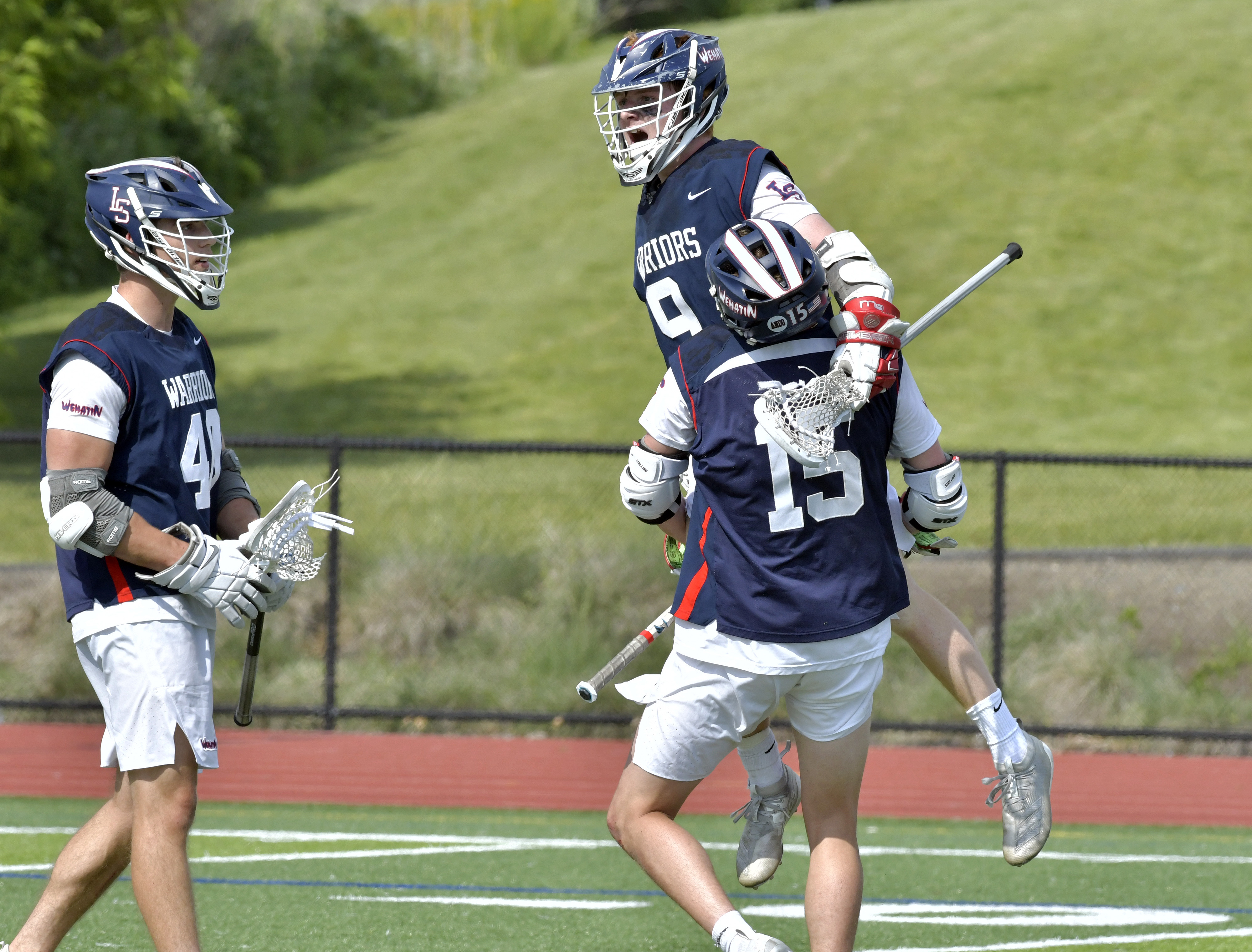 David Herlihy (top) and Lincoln-Sudbury teammates celebrate a goal during their 14-13 win.