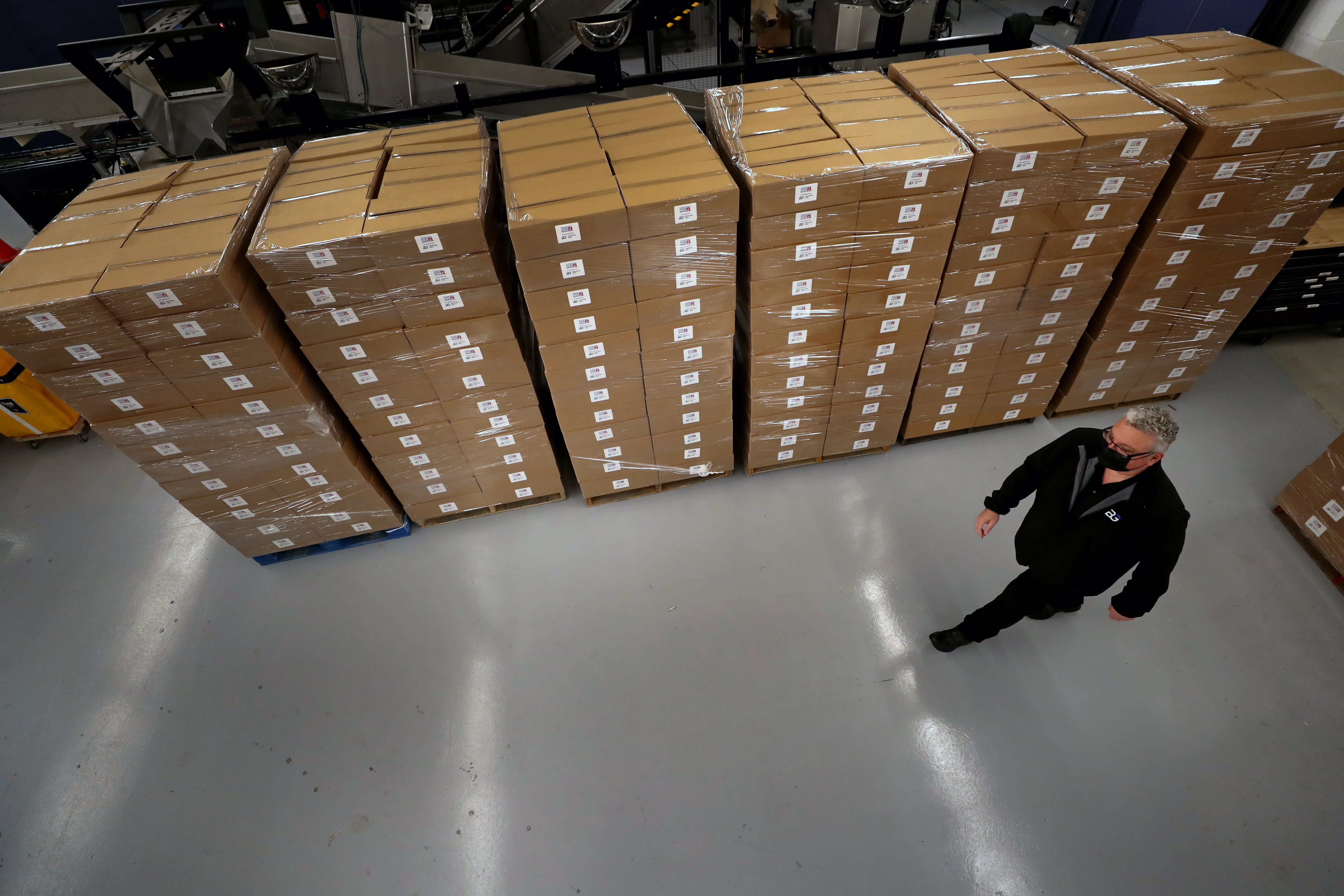 Berkshire Grey chief executive Tom Wagner walked past boxes of food packed by the company's robots in Bedford.