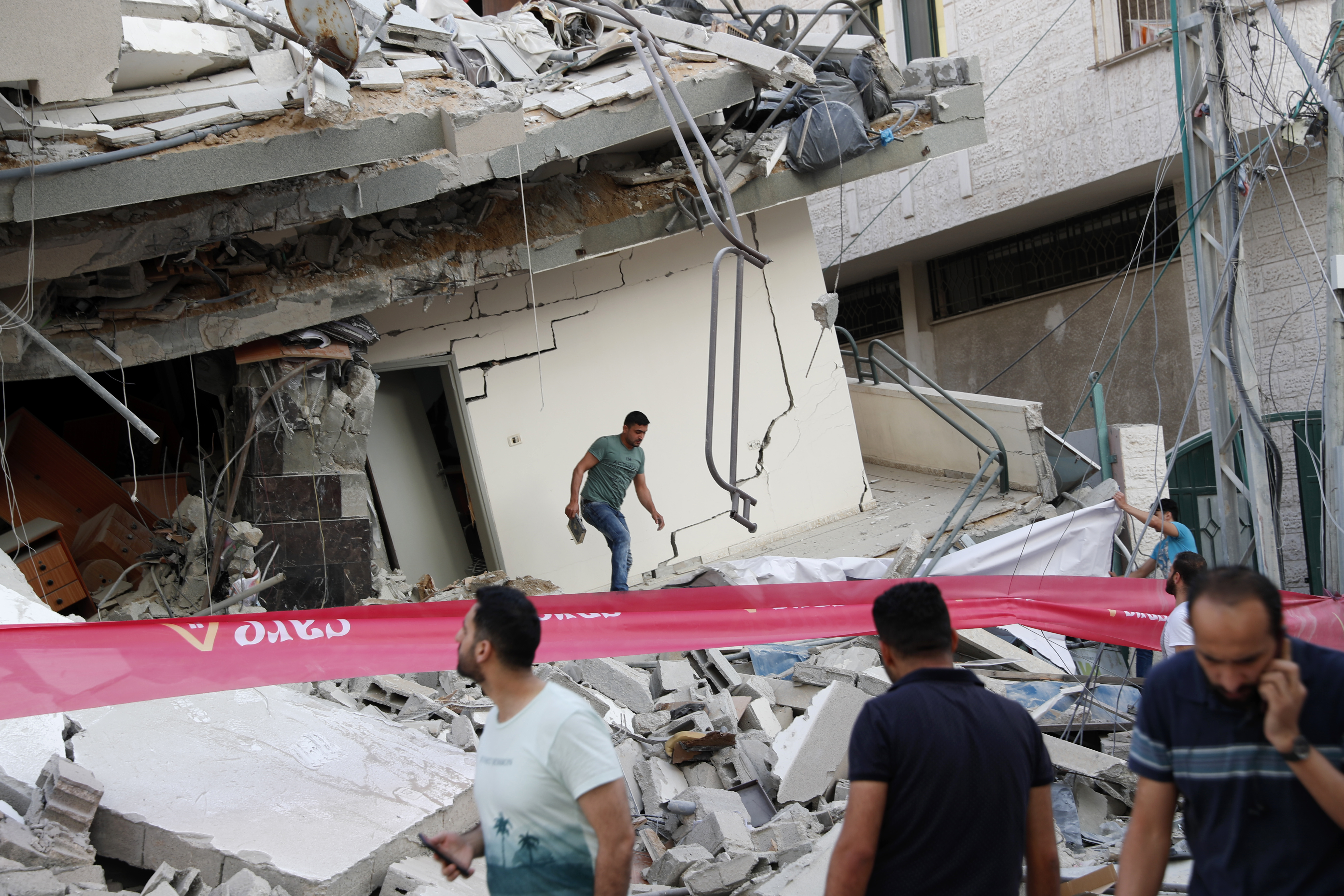 People inspected the rubble of destroyed residential building that was hit by an Israeli airstrike in Gaza City.