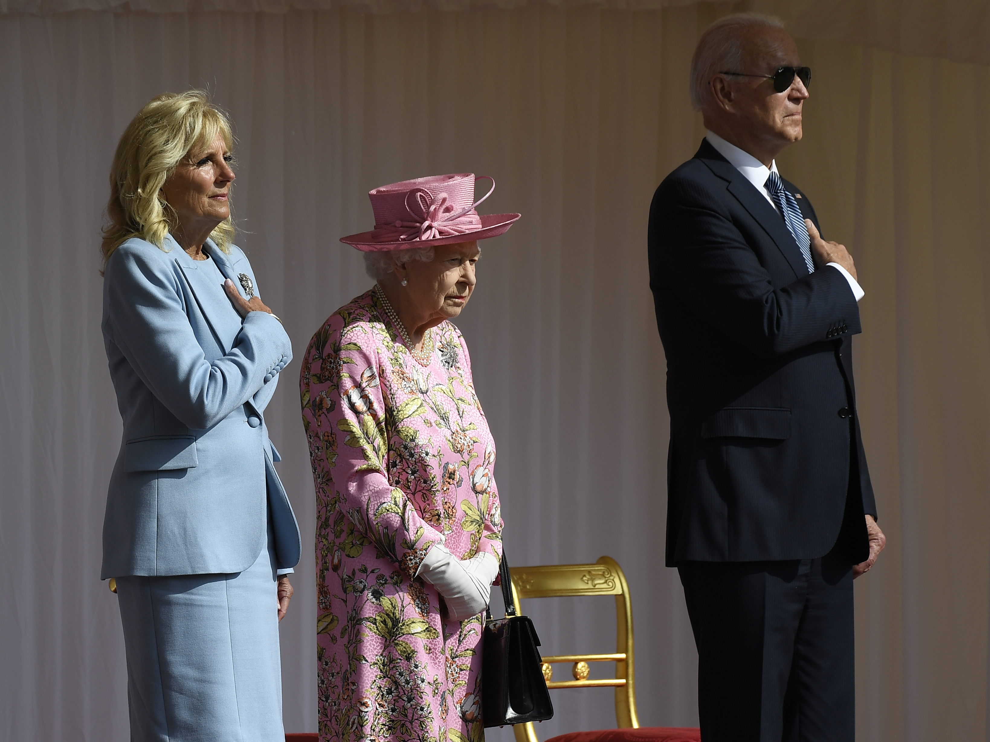 Queen Elizabeth II stood with Jill Biden and President Biden during the US national anthem at Windsor Castle.