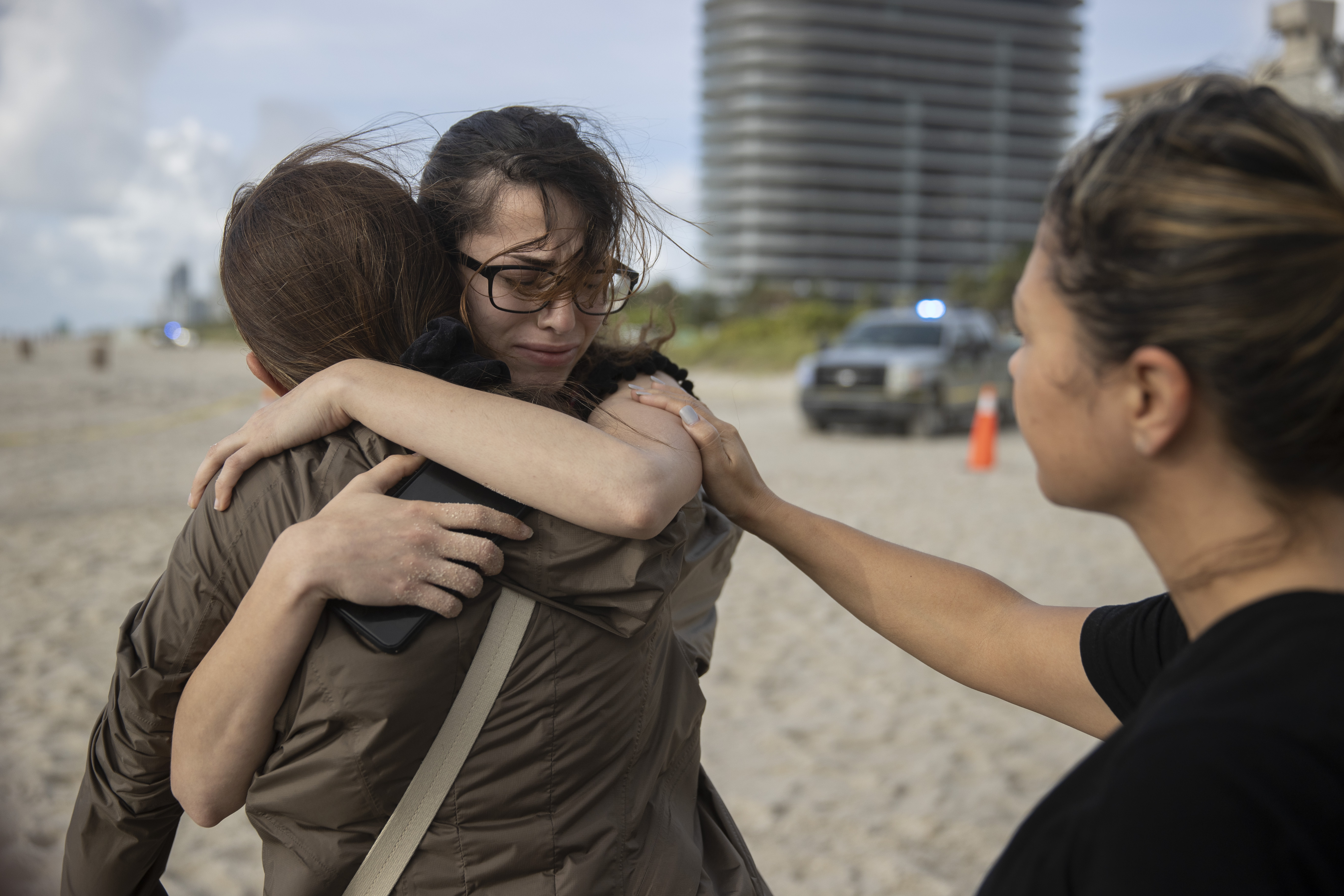 Maria Fernanda Martinez, Fayzah Bushnaq, and Mariana Cordeiro comforted each other near where search and rescue operations continued.