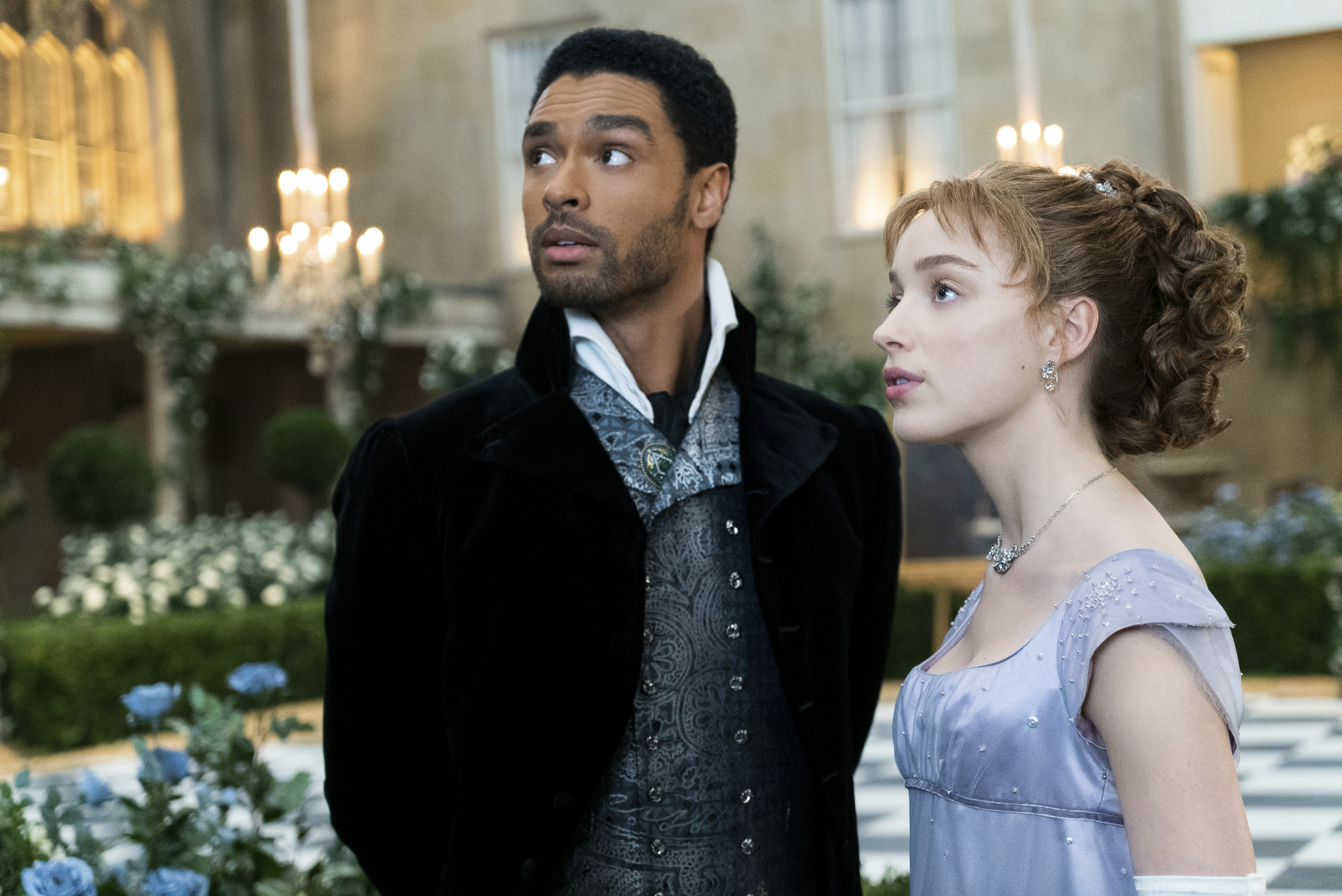 Phoebe Dynevor, right, and Rege-Jean Page in a scene from "Bridgerton." The program is nominated for an Emmy Award for outstanding drama series.