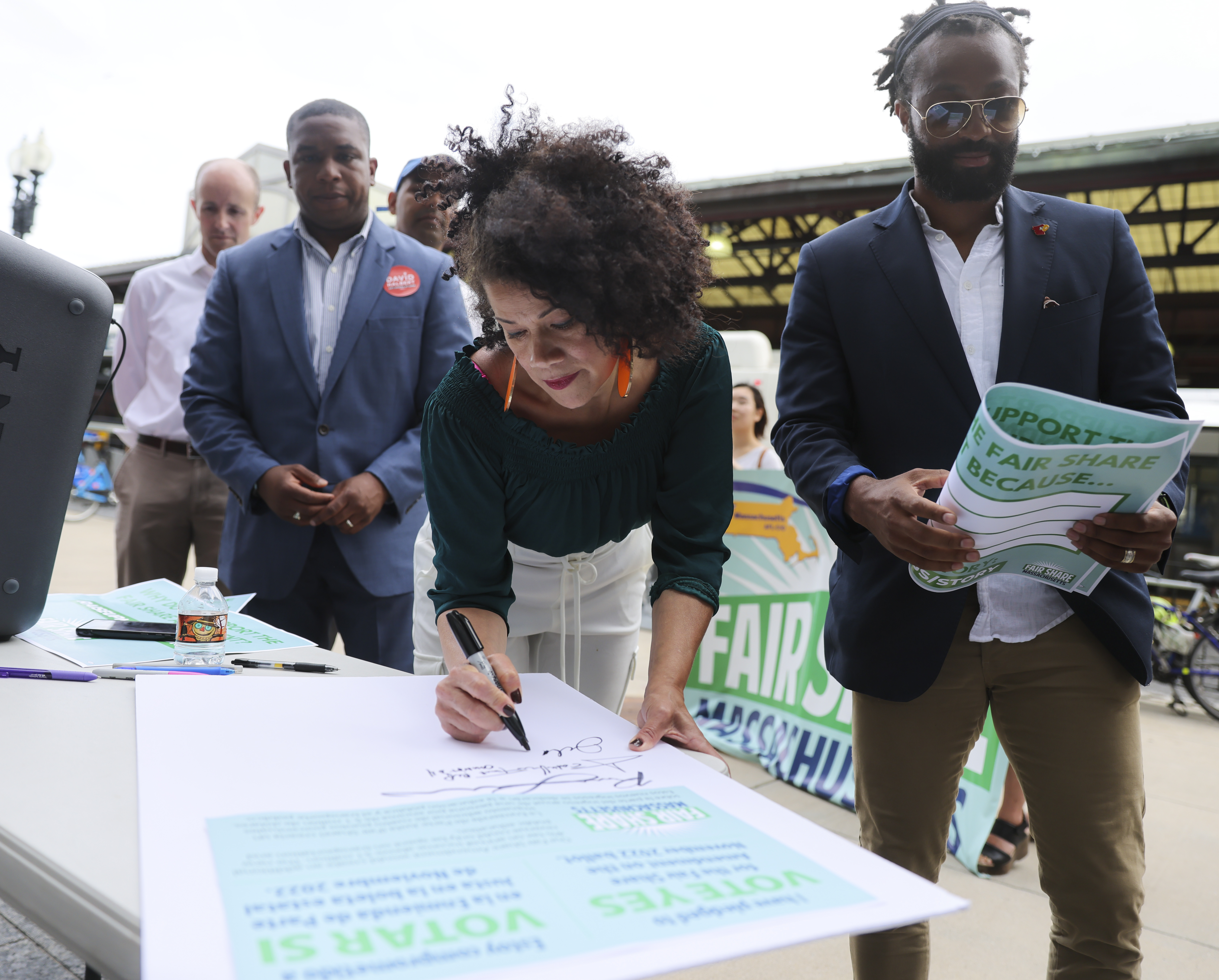 Boston City Councilor Julia Mejia was among the politicians signing a petition in support of the Fair Share Amendment campaign during a rally in June.