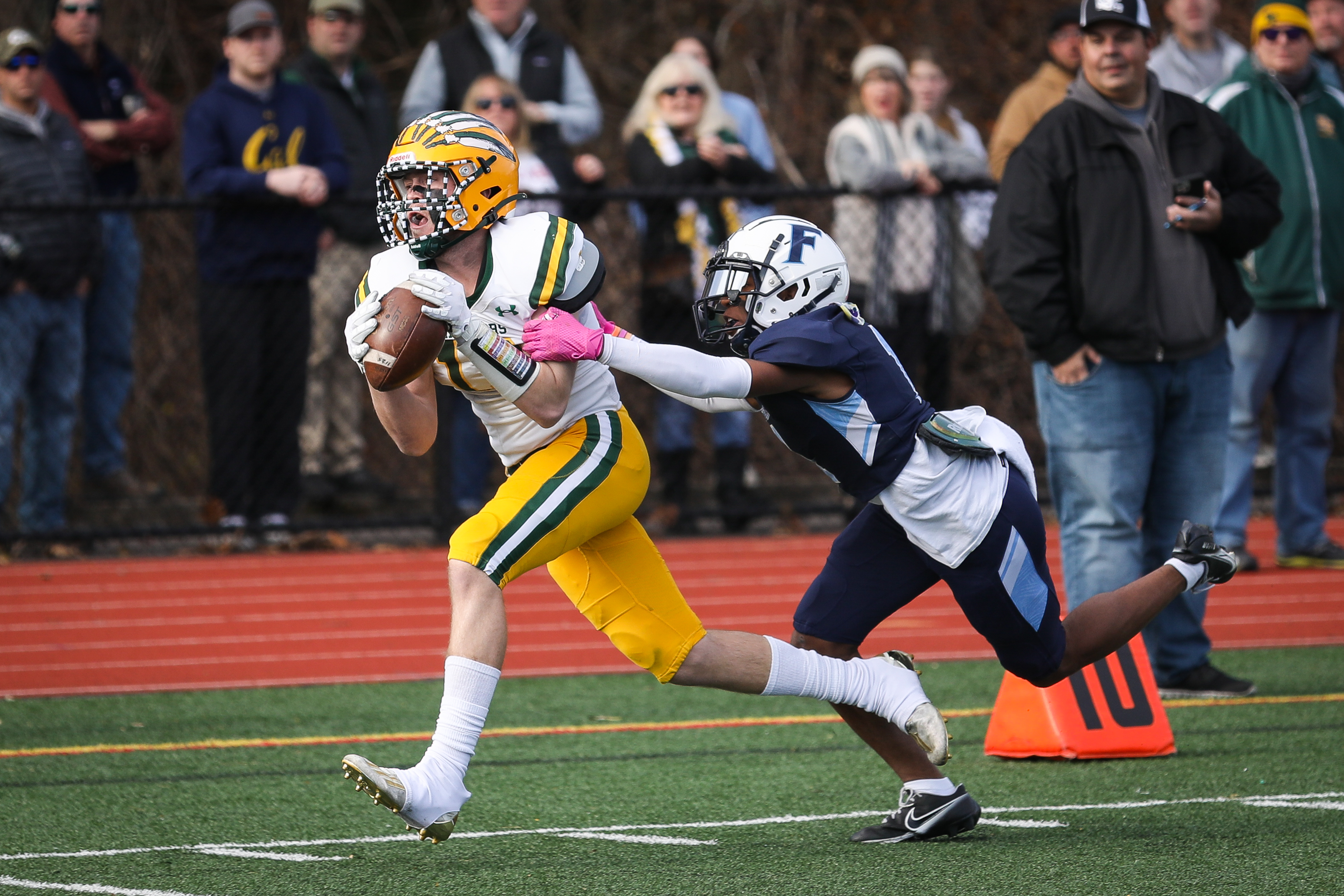 King Philip senior Daniel Clancy (13) makes a catch in front of Franklin junior Devine Johnson (1) in the first quarter Thursday morning.