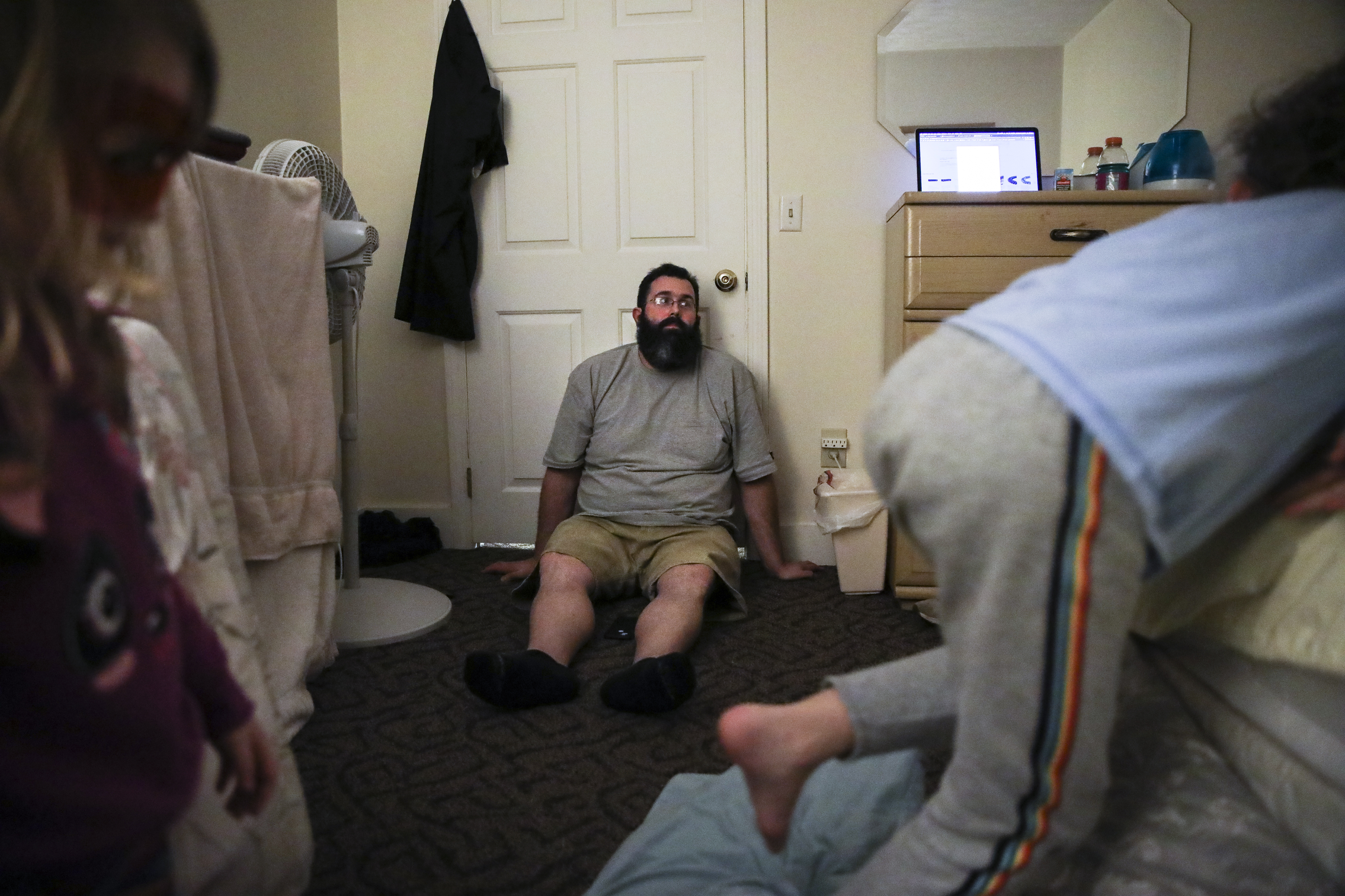 Exhausted, Patrick leans against the bedroom door while his daughter Laya and son Evan jump back and forth on the bed. Often forced to share one room while at a shelter, the family of five needs more space. Two weeks after the family moved south to New Hampshire, Patrick got a job as a field engineer at Granite State Communications. His salary was $80,000, double what he was making in Maine. Now that Patrick had a well-paying job, they turned to the next hurdle: finding an affordable apartment that could comfortably fit their family.