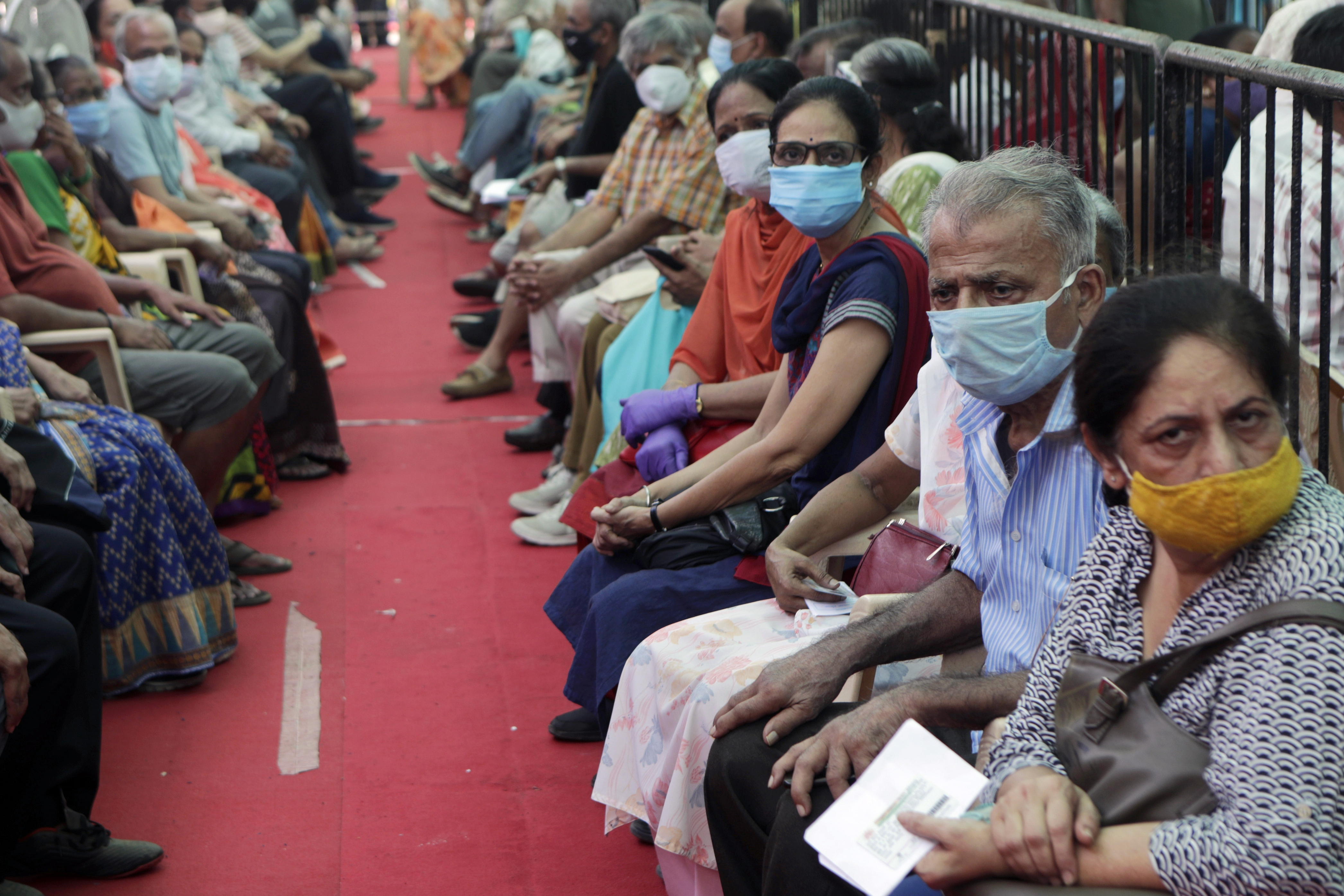 People waited to receive COVID-19 vaccine in Mumbai on Thursday.