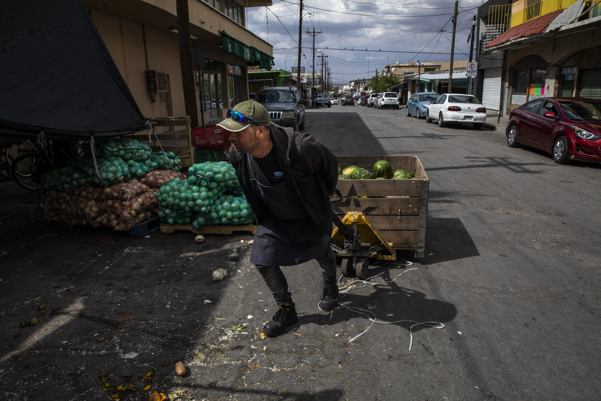 Manuel Gonzalez, 35, pulled a crate of watermelons while working at a market in Juarez. Gonzalez migrated from Cuba over a year ago to attempt to seek asylum in the US. He has been working at markets in Juarez for the past year while he waits to see if immigration restrictions are lifted.