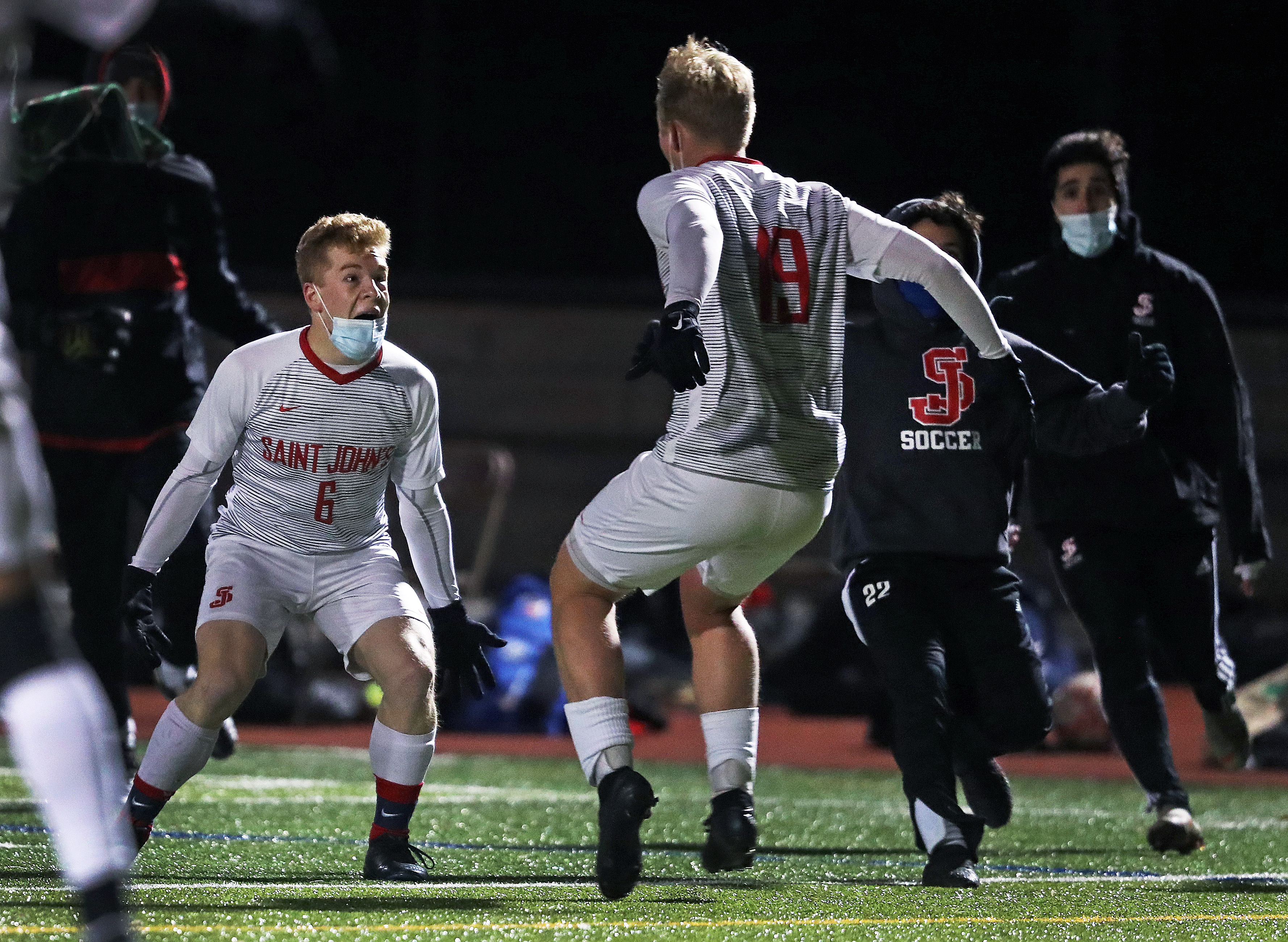 St. John's players Eli Saunier (left) and teammate Edmund Hughes (right) start the celebration following the Pioneers' 2-1 victory over BC High in the Catholic Conference soccer championship.