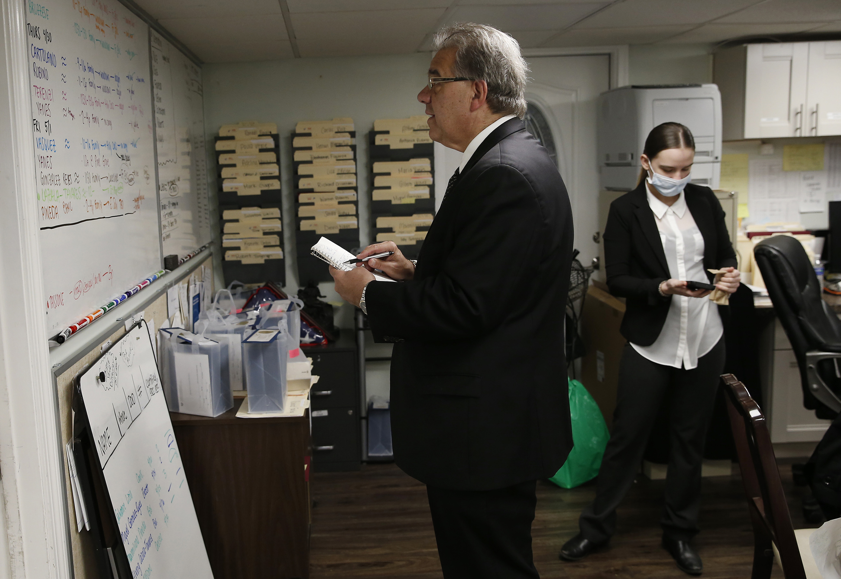 Funeral director Joe Ruggiero Jr., founder of his family’s business, Ruggiero Family Memorial Home in East Boston, looked up at the white board full of funerals for the week as he tried to figure out the next day’s staffing beside his daughter, Catie.