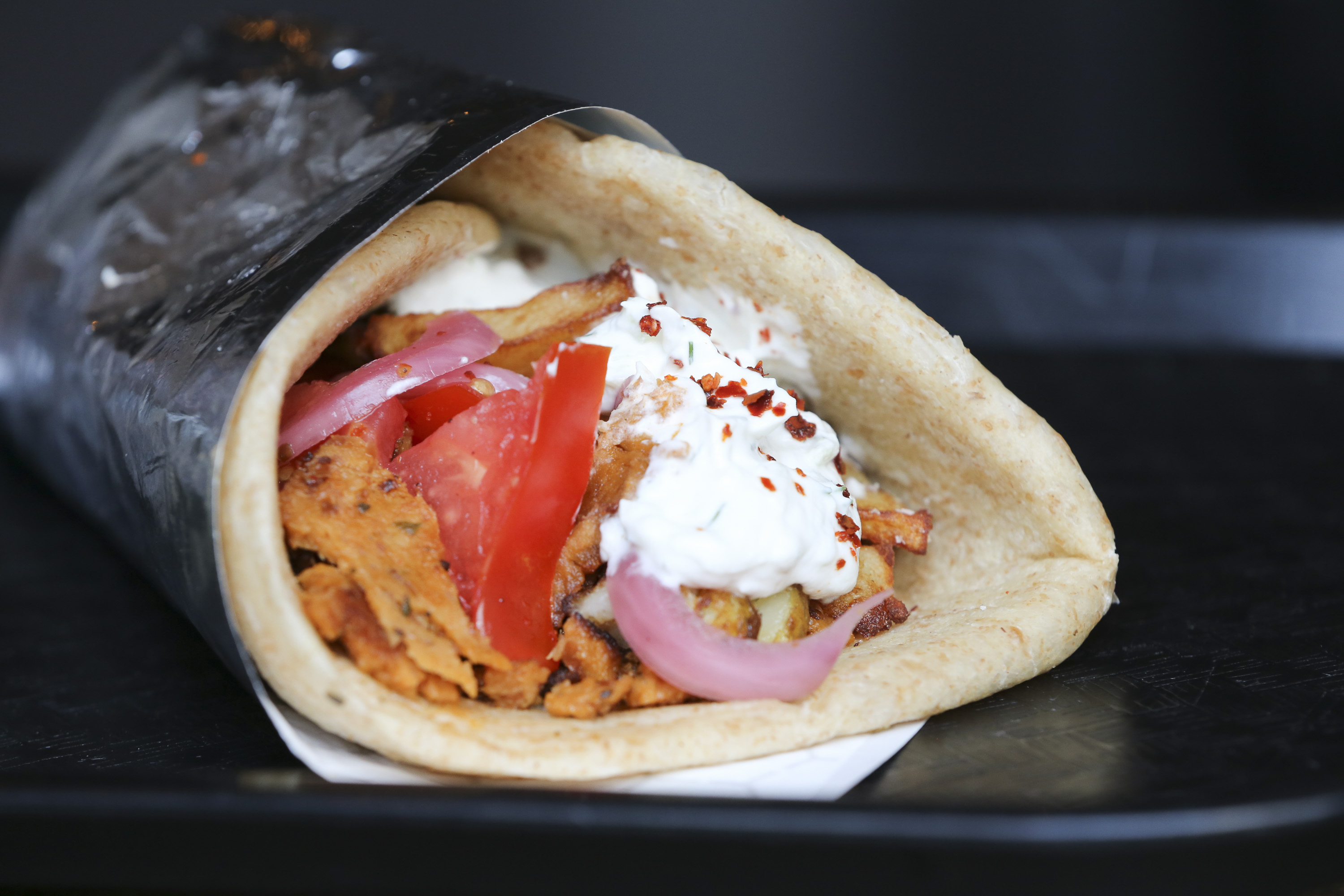 The gyro, made with seitan, pickled onion, almond tzaziki, tomato, and fried potato, is a signature item at Littleburg, a Greek-inspired, seasonal vegan kitchen for takeout in Union Square. 