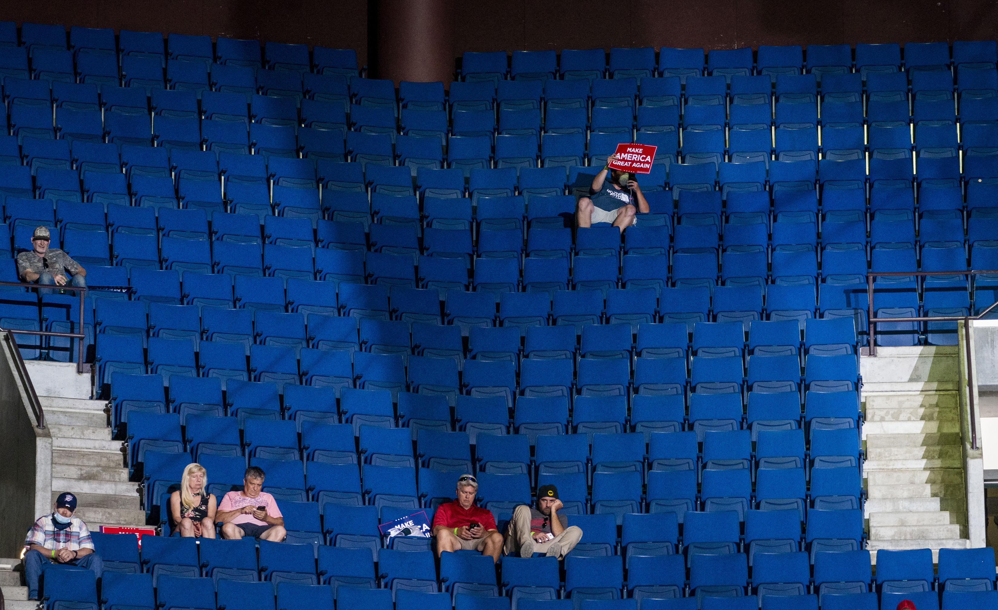 Supporters of President Donald Trump listen as he speaks at the BOK Center, in Tulsa on Saturday, during his first campaign rally since March 2. Inside the campaign, advisers believe disappointing attendance at the rally shows genuine fear of the coronavirus and the reality of President Trump’s sliding poll numbers.