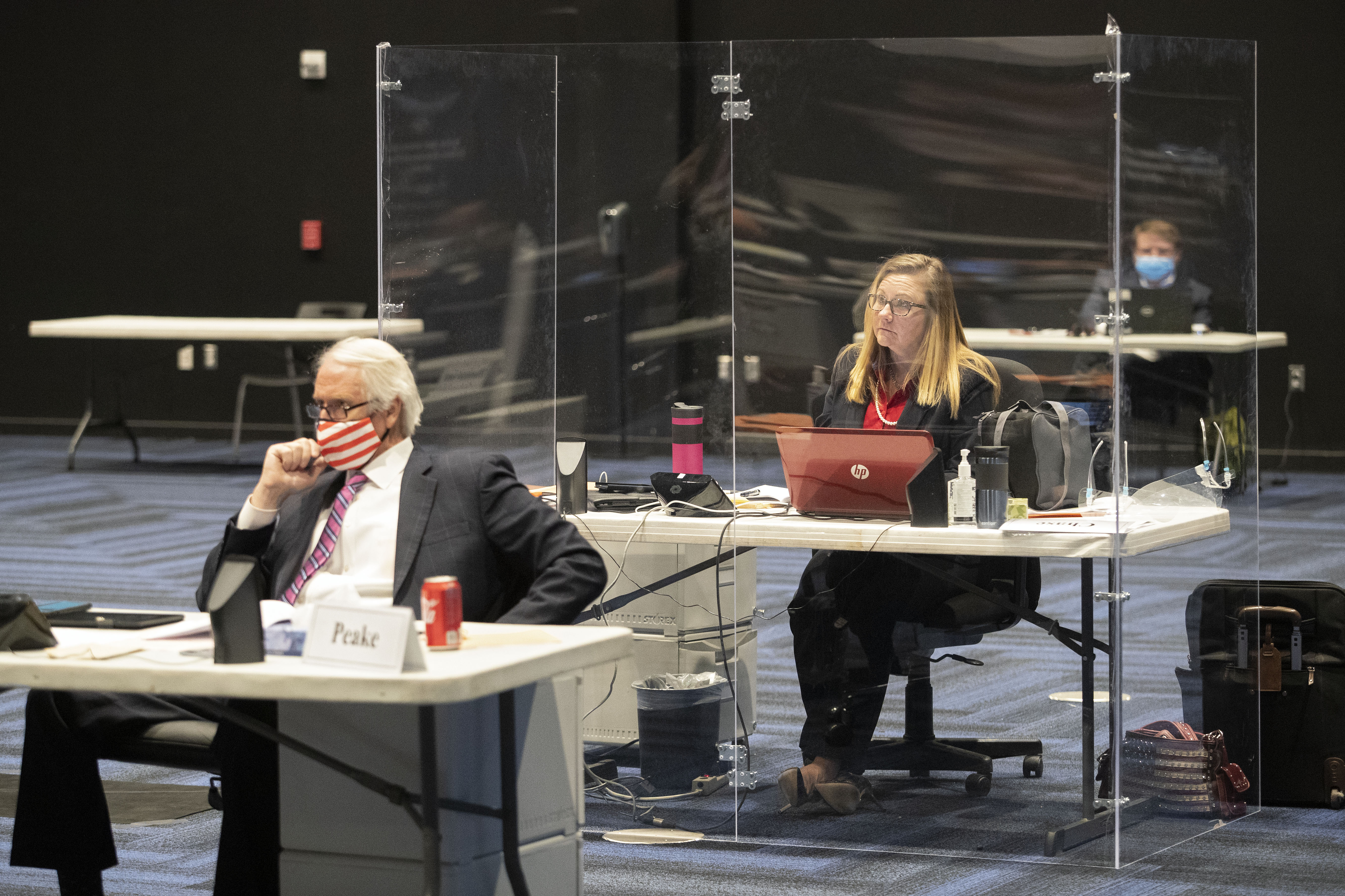Virginia state Senator Amanda Chase sat at a desk surrounded by plexiglass during a special Senate session in Richmond, Va., on Feb. 2. The arrangement was required for coronavirus protection because she said she has a health issue that prevents her from wearing a mask.