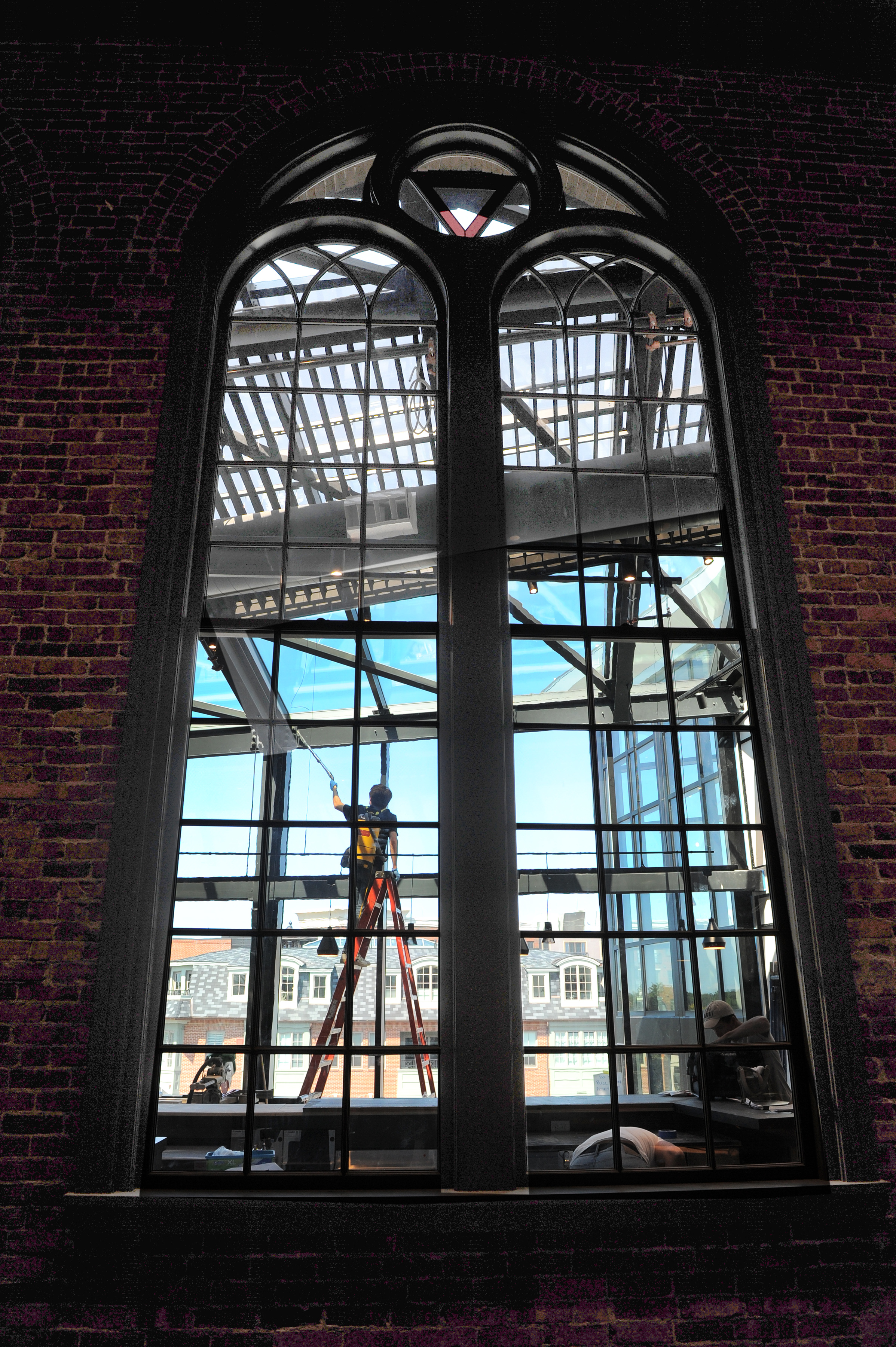 A worker is seen through an arched window at Jimmy's Jazz & Blues Club, opening in a fully restored century-old building in downtown Portsmouth, N.H.