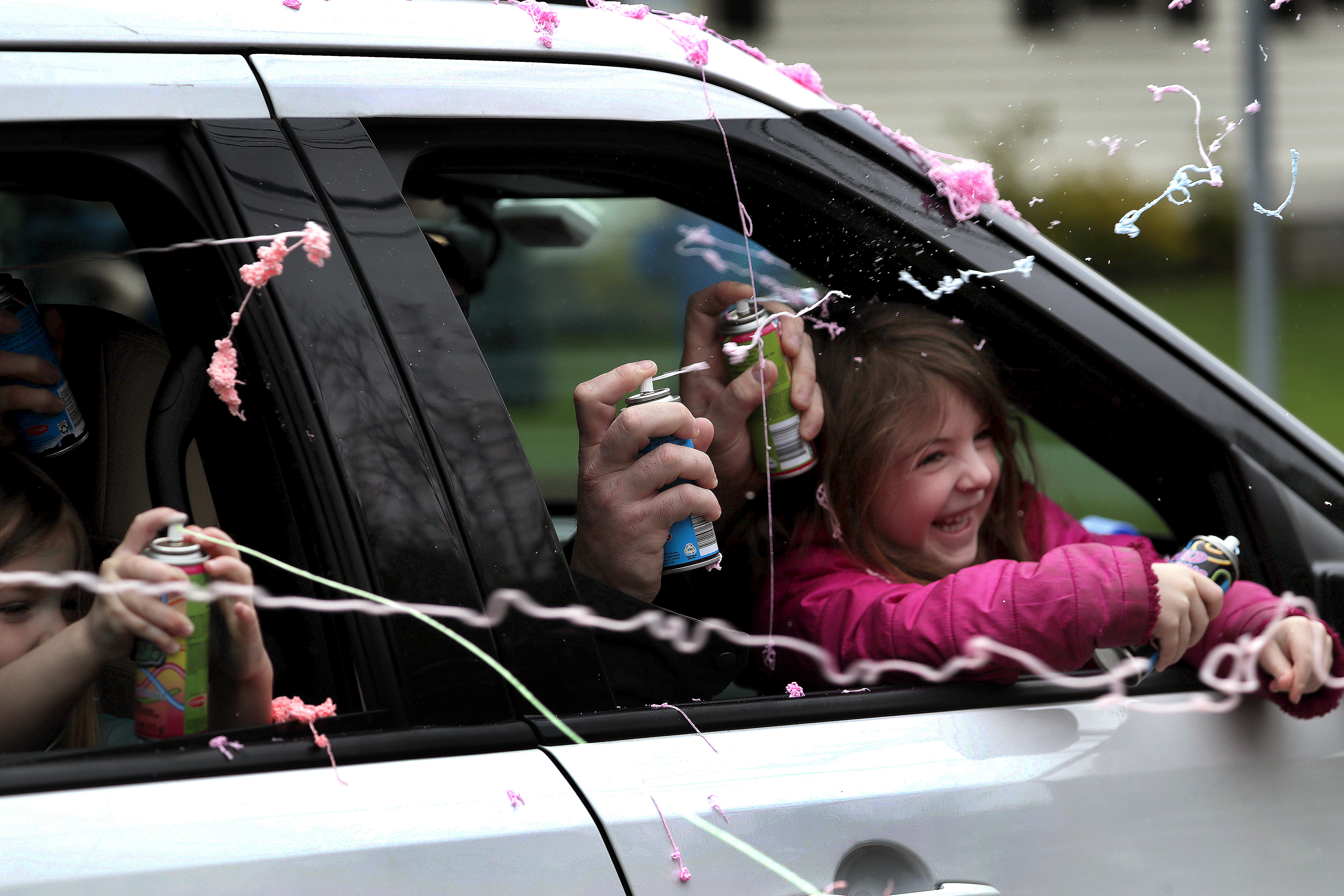 Dedham, MA - 4/30/2020: A drive-by birthday parade for Gavin Brennan of Dedham who celebrated his seventh birthday and successfully completing cancer treatment at Children's Hospital/Dana Farber. Gavin was among the first pediatric cancer patients in the nation to test positive for COVID-19 while undergoing chemotherapy. Pictured with Gavin are his sister Alexa, 4, and his parents Tim and April Brennan. - (Barry Chin/Globe Staff)