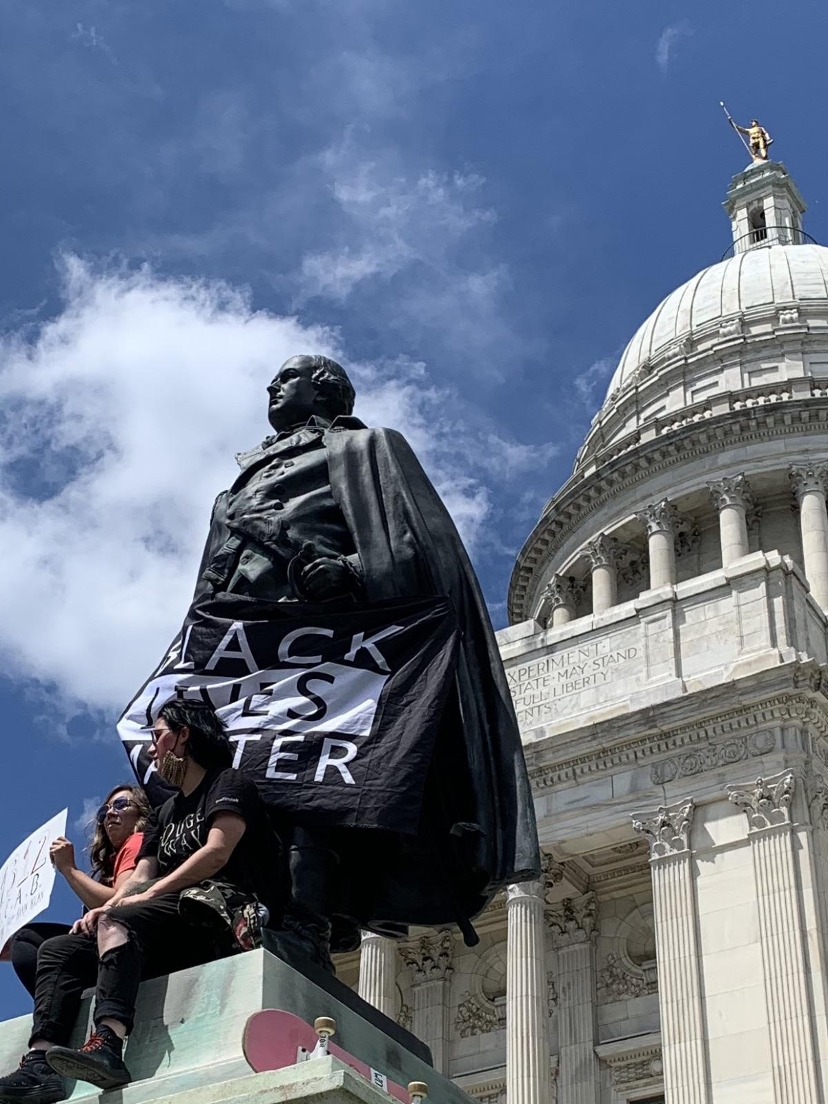 Protesters hung a "Black Lives Matter" banner on the statue of Major General Nathanael Greene outside the Rhode Island State House in May 2020.