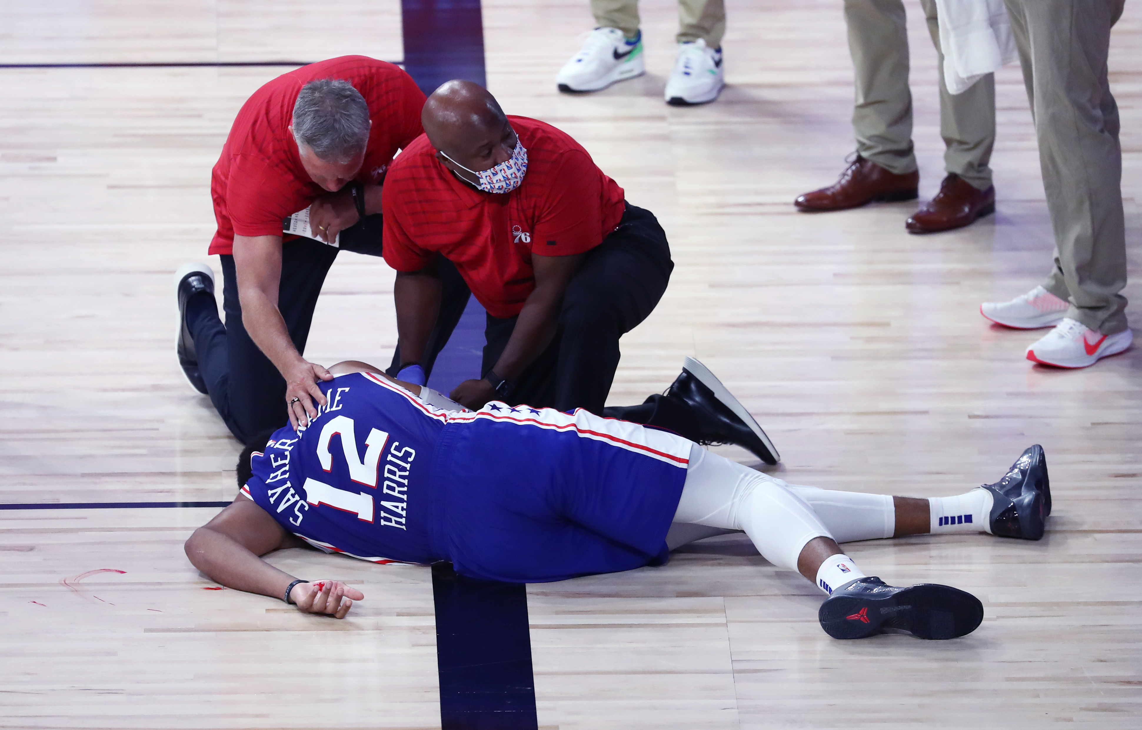 Head coach Brett Brown reacts as Tobias Harris is attended to after hitting his head during the third quarter of Sunday's game.