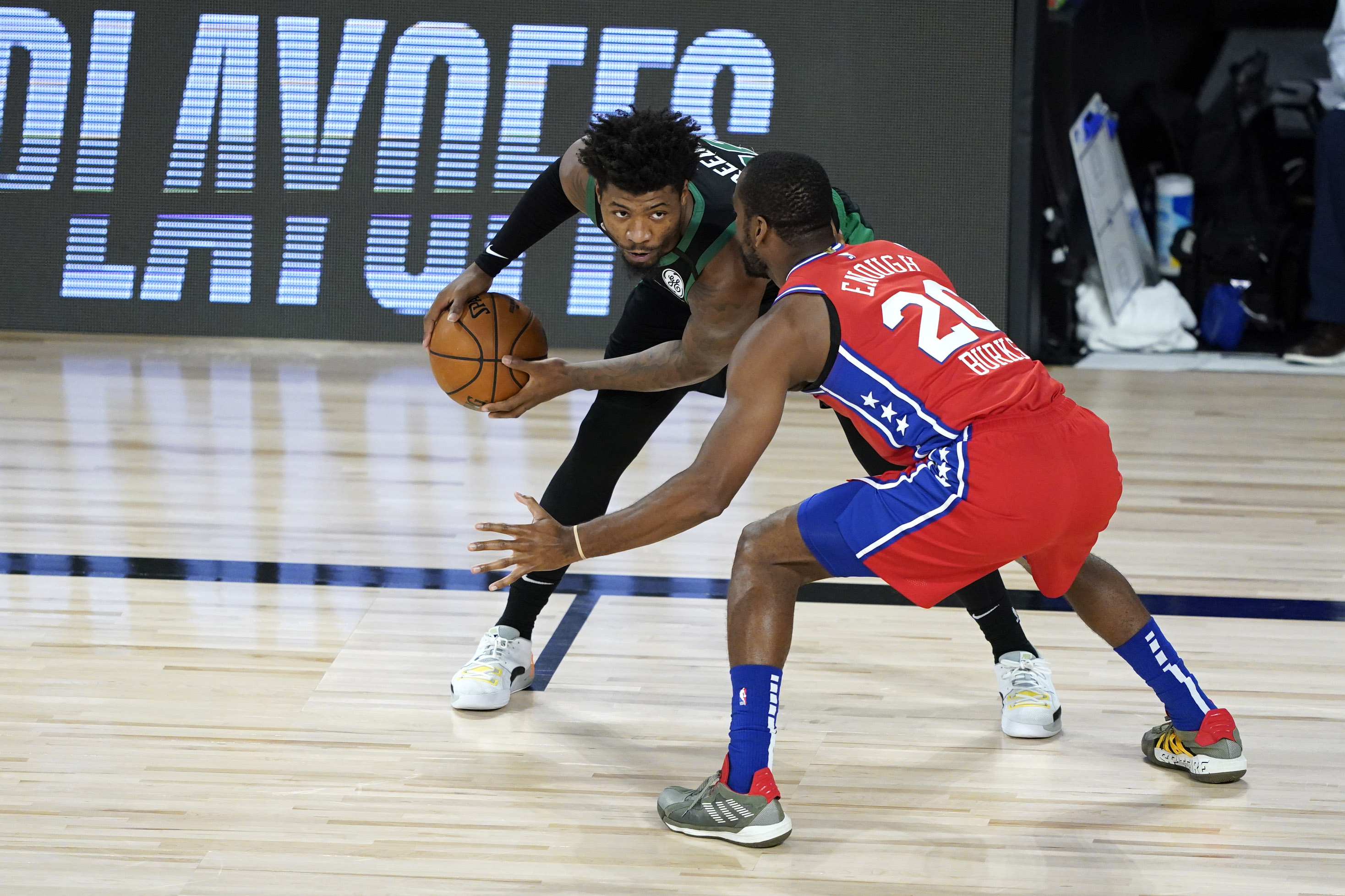 Marcus Smart controls the ball against Philadelphia's Alec Burks in the first half of Monday's game.