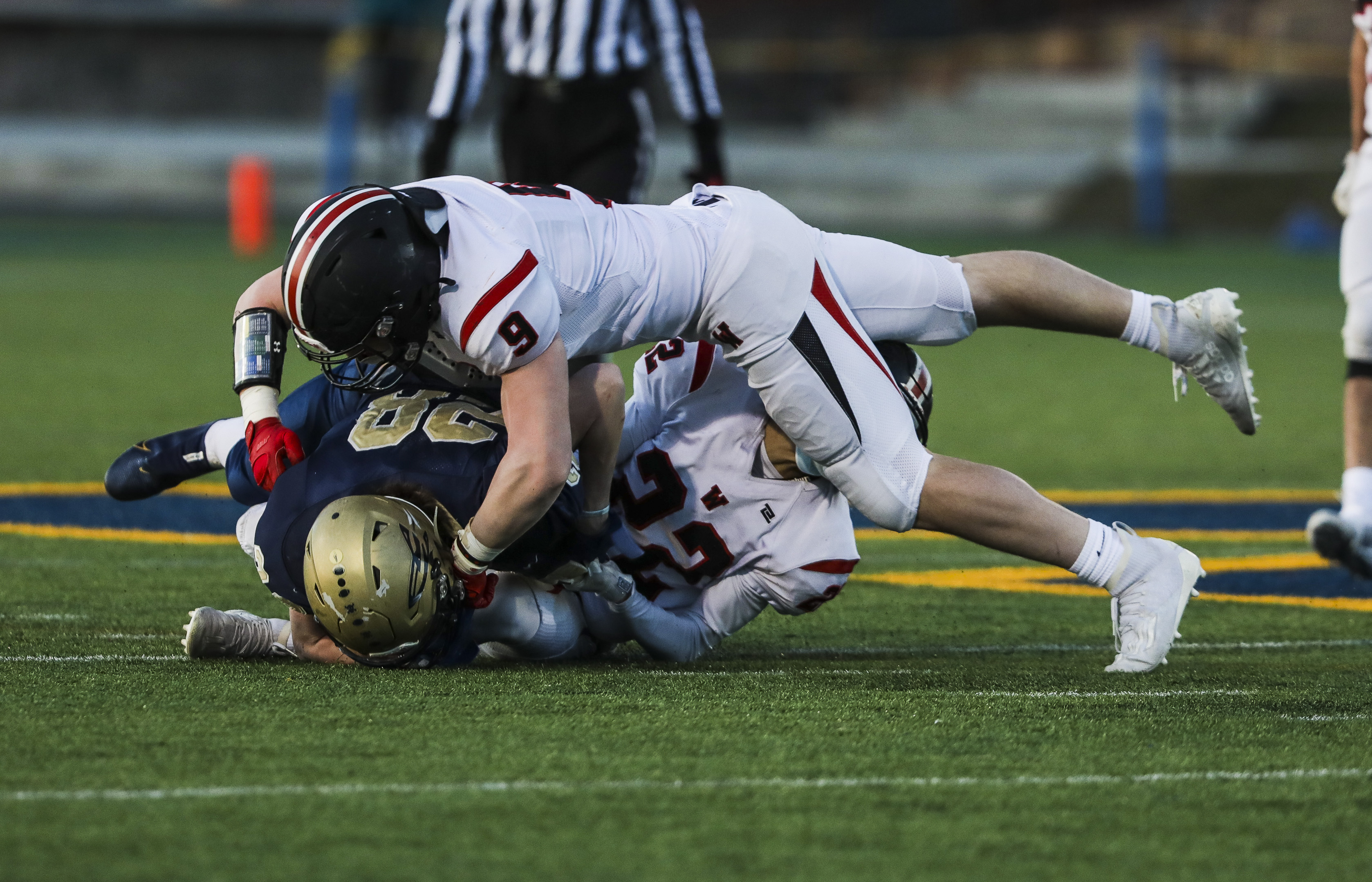Wellesley's Jakob Parker (9) tackles Needham's Thomas Fullbrook during Friday's game.