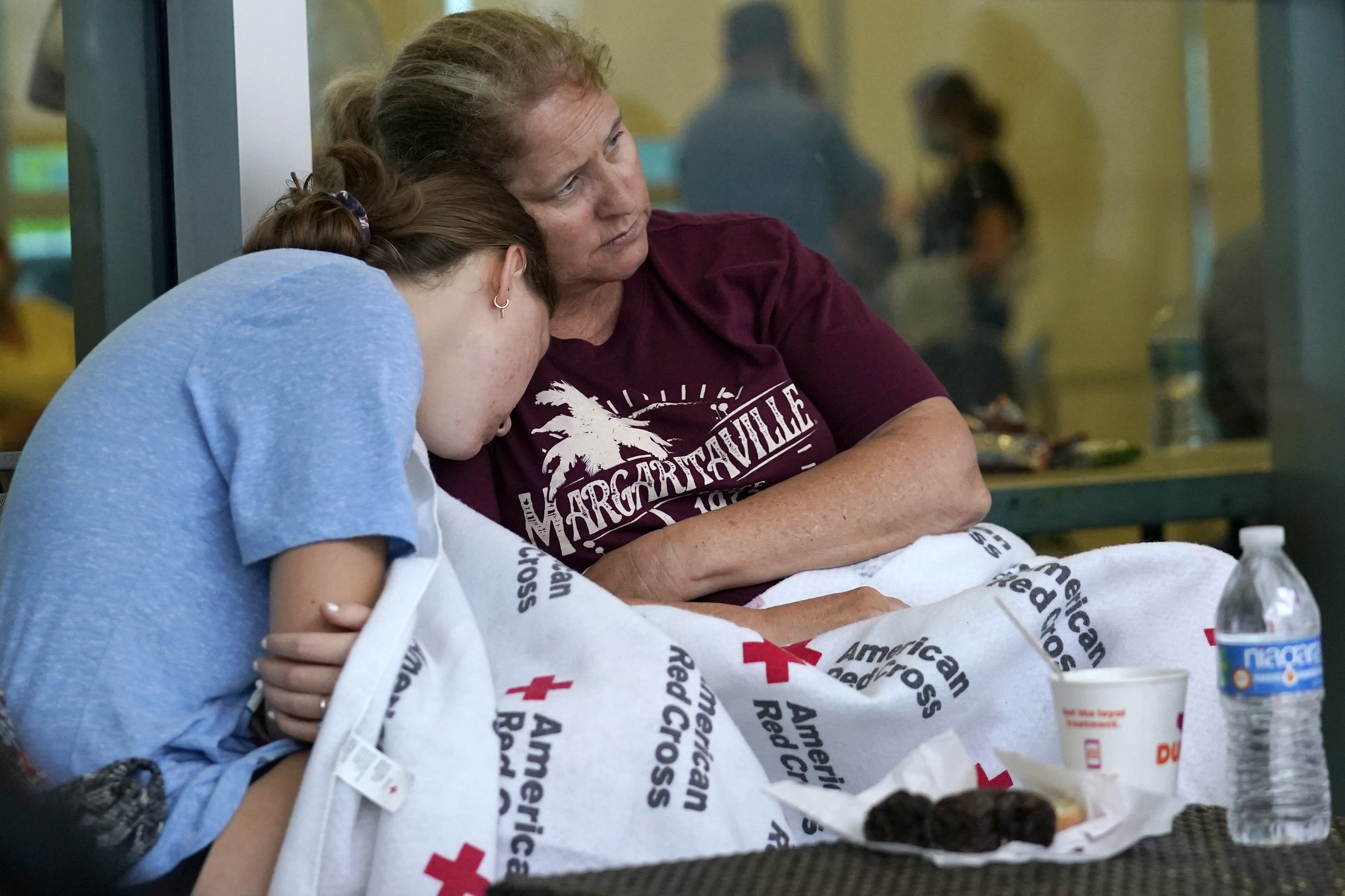 Jennifer Carr, right, sat with her daughter as they waited for news at a family reunification center.
