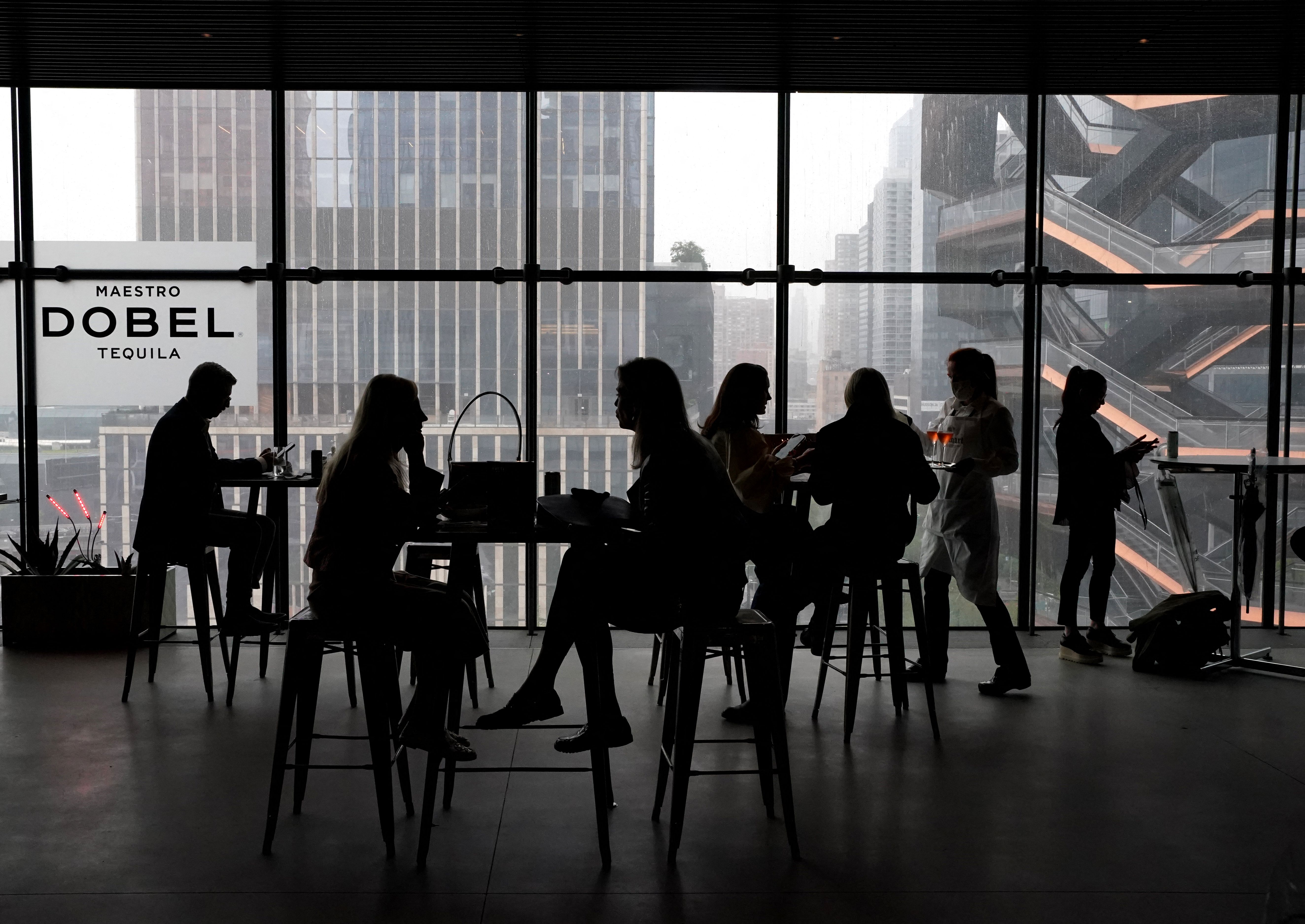 People sit in the cafe during the first day of Frieze art fair in New York on May 5. Frieze is the first art fair to return to the city since the pandemic, at The Shed, a nonprofit cultural institution in Manhattan's Hudson Yards.