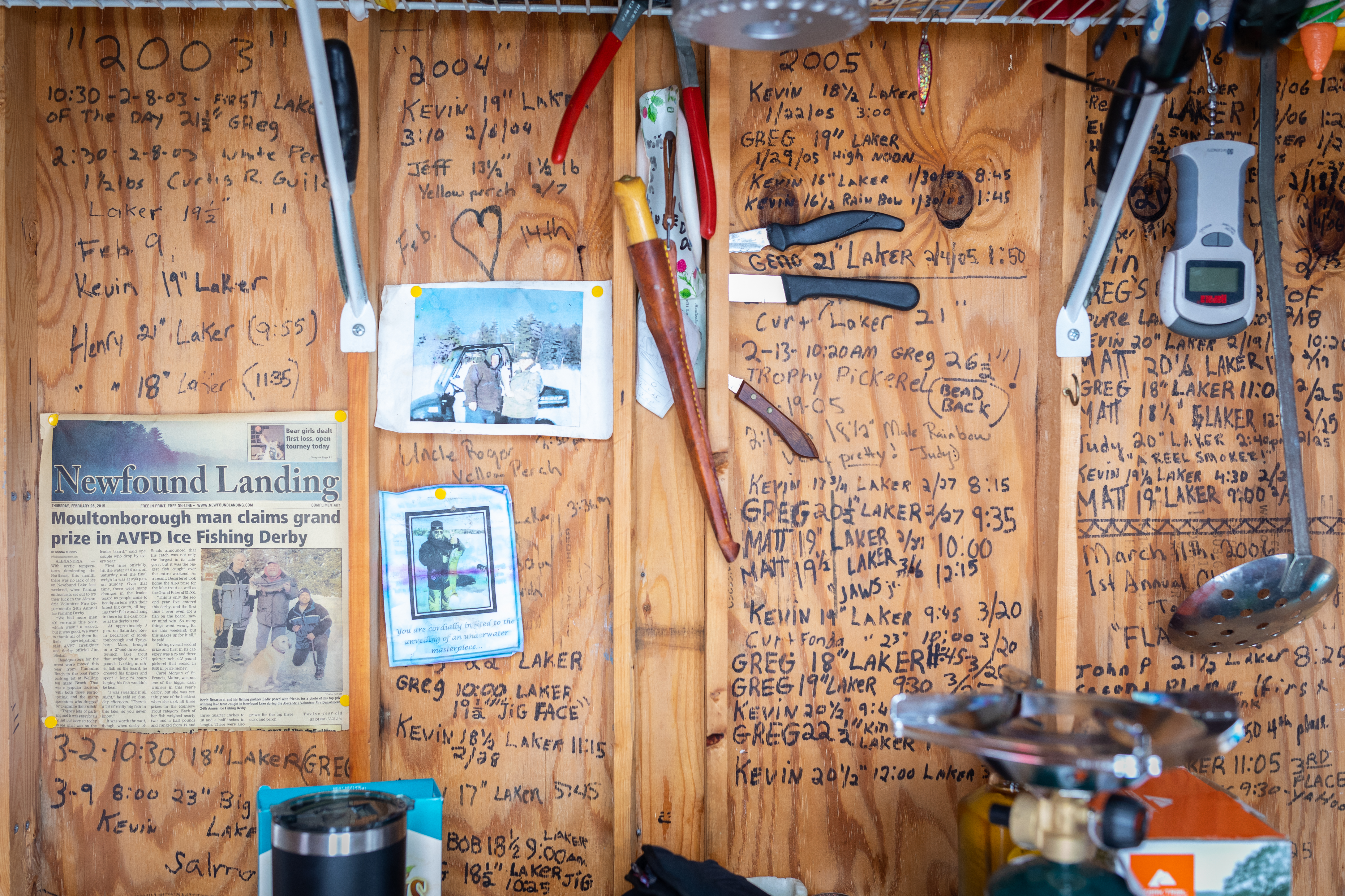 The inside of a bob house owned by Kevin and Greg DeCarteret adorned with news clippings and records of every fish caught since 1998 during the Lake Winnipesaukee ice fishing derby in Moultonborough, N.H.