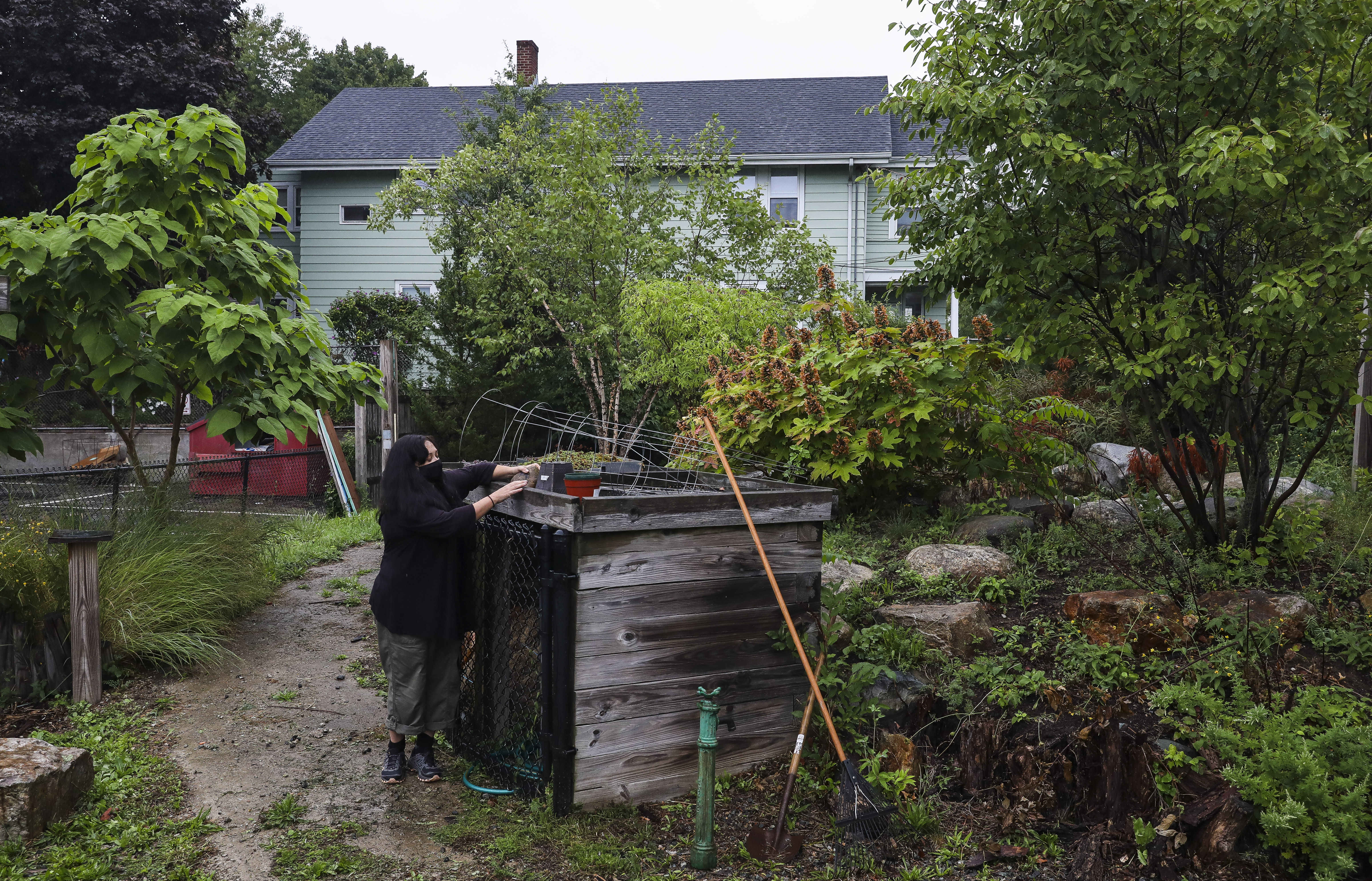 Carolina Castillo-Carbona secured compost while working with raised-bed gardens.