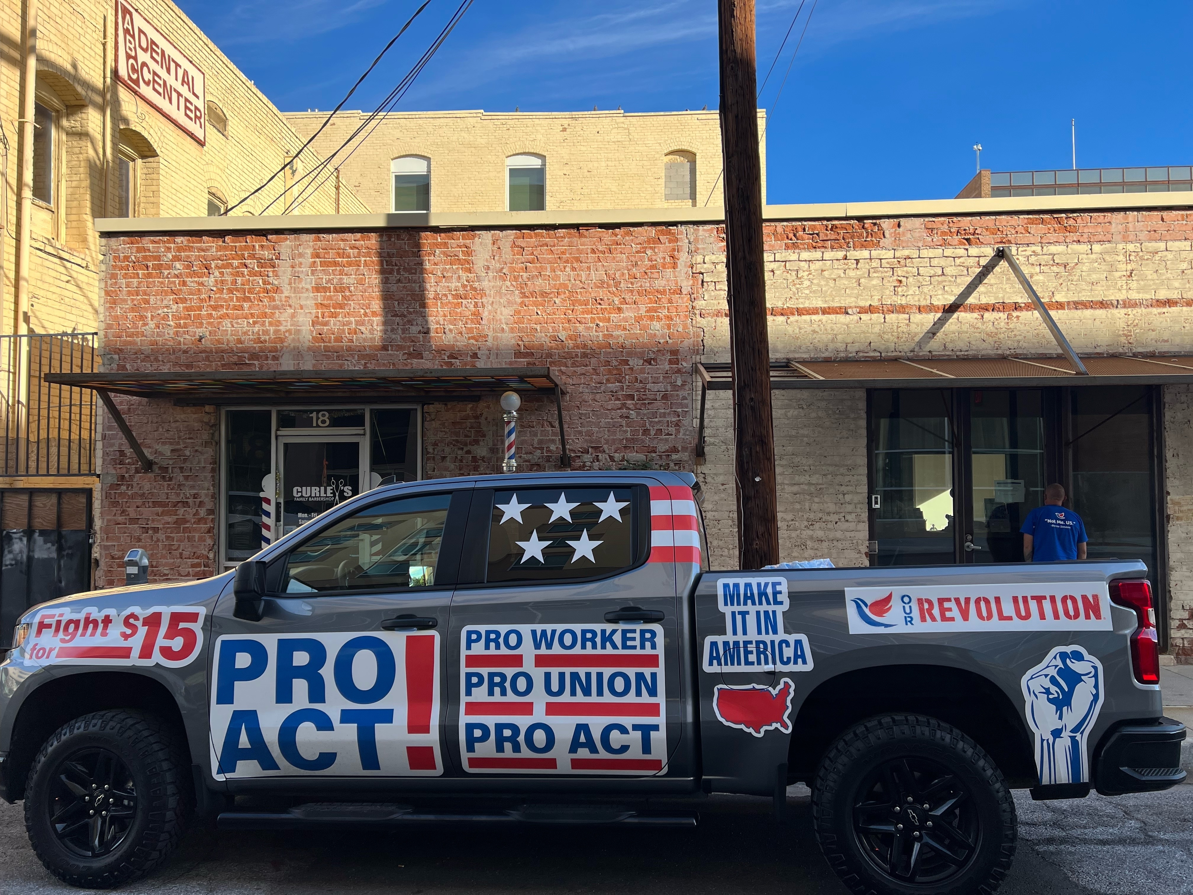 A pickup truck with signs championing worker and union causes that Our Revolution brings to protests, in Arizona.