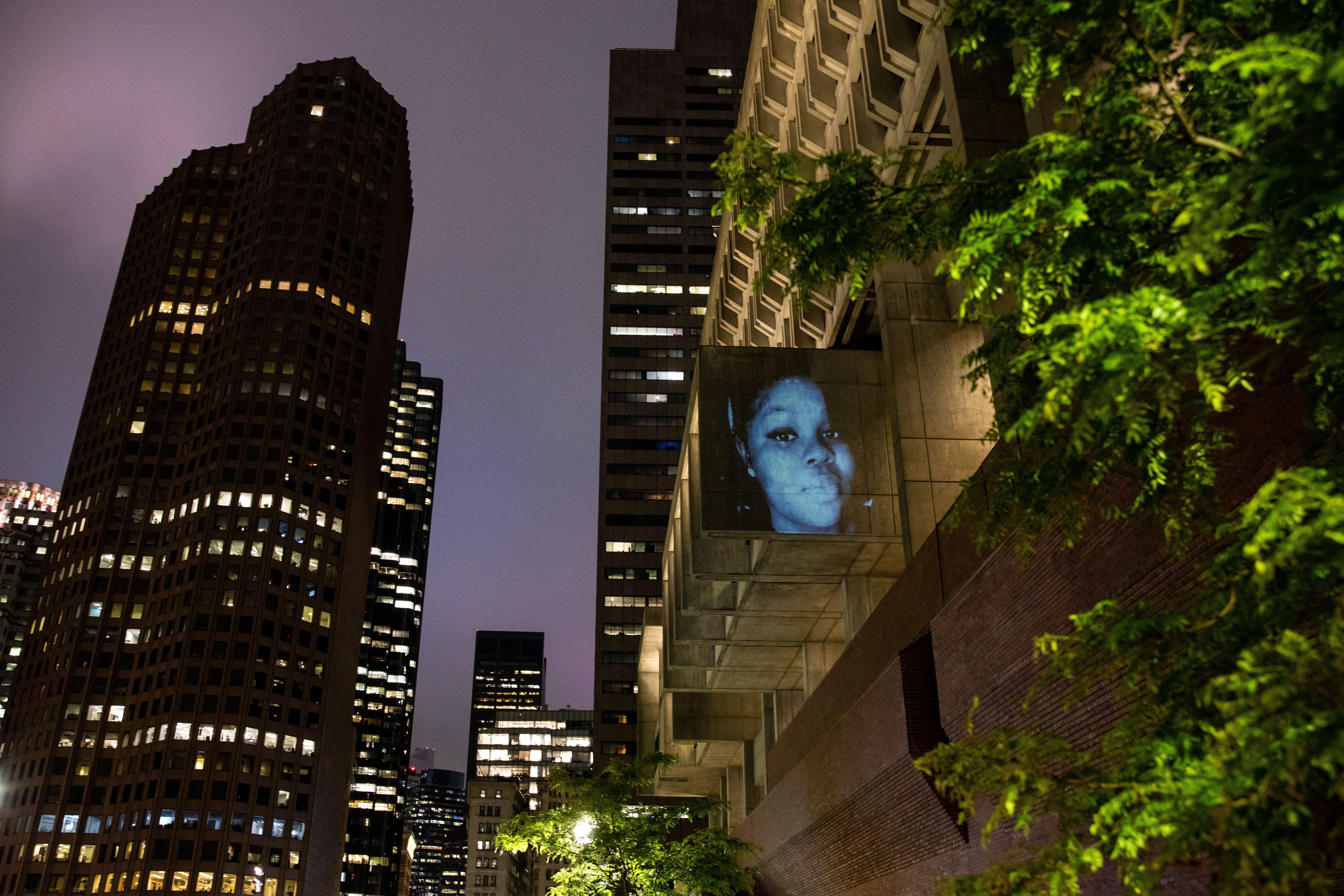 Projection Protests by Sam Okerstrom-Lang and Caleb Hawkins of MASARY Studios, with Breonna Taylor's face illuminating Boston City Hall.