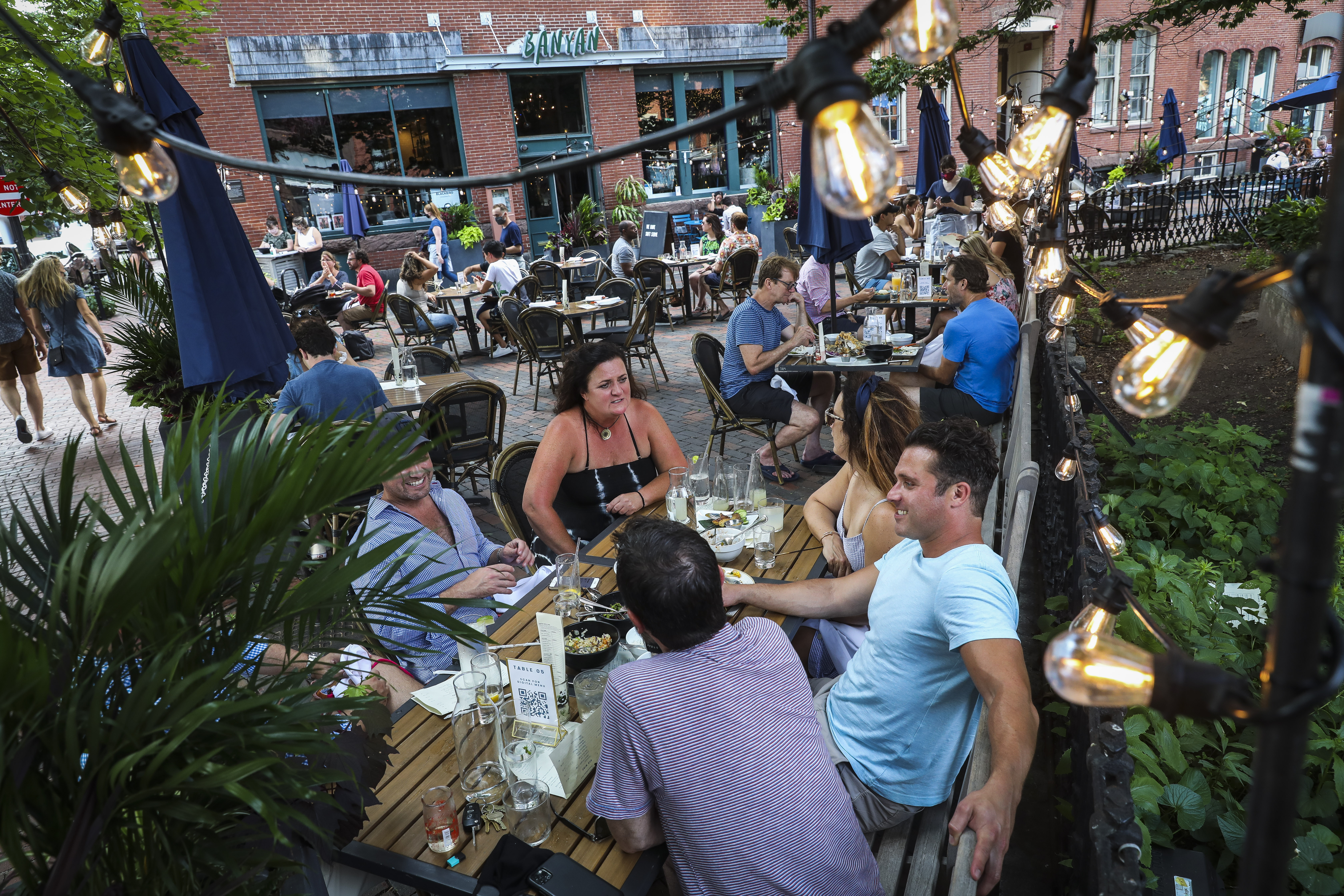 People sit on the patio at Banyan Bar + Refuge in the South End.