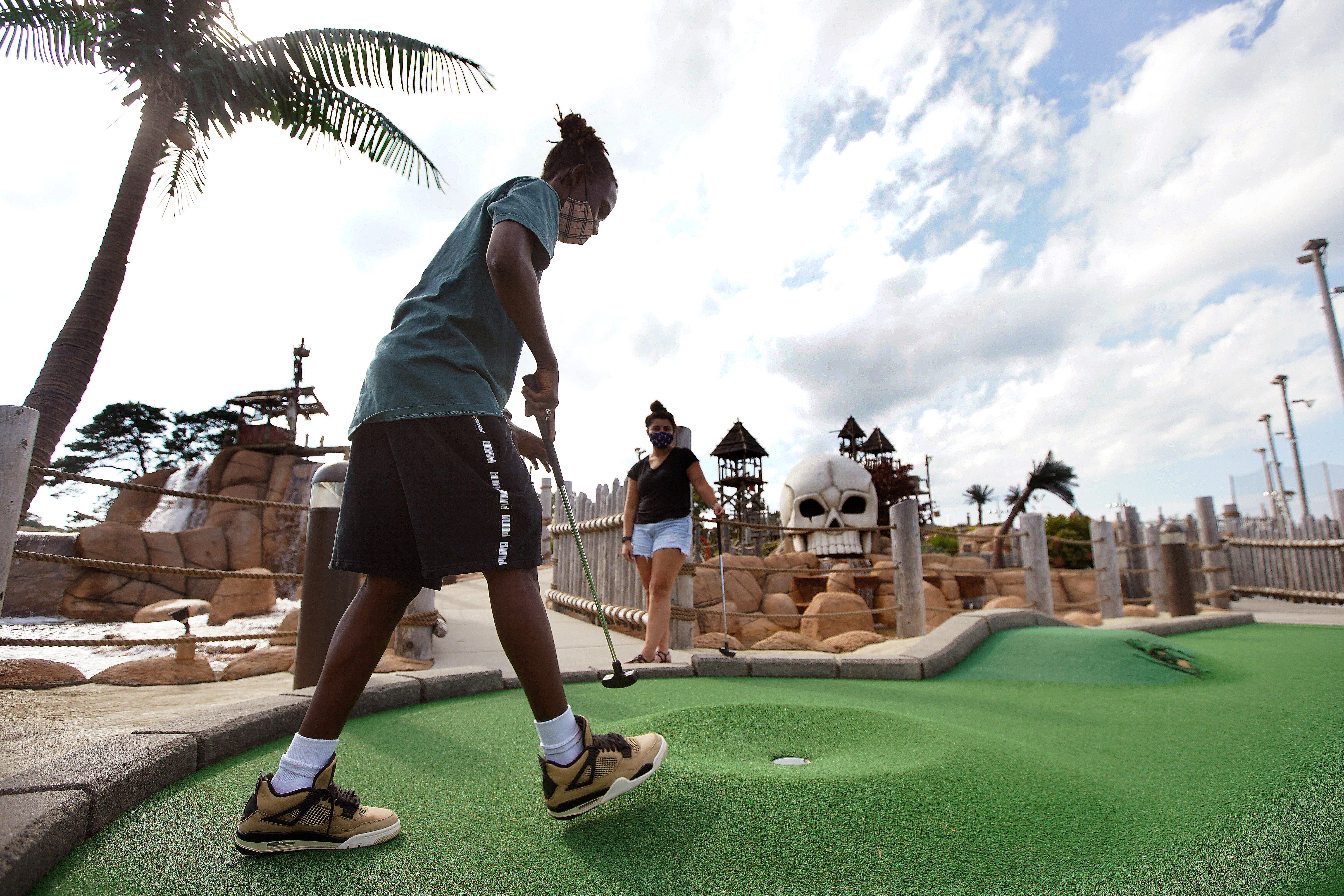 Niki Ndegwa, 20, of Worcester (left) and Sophia Arredondo, 21, of Malden on the mini golf course at Skull Island Adventure Golf in South Yarmouth.