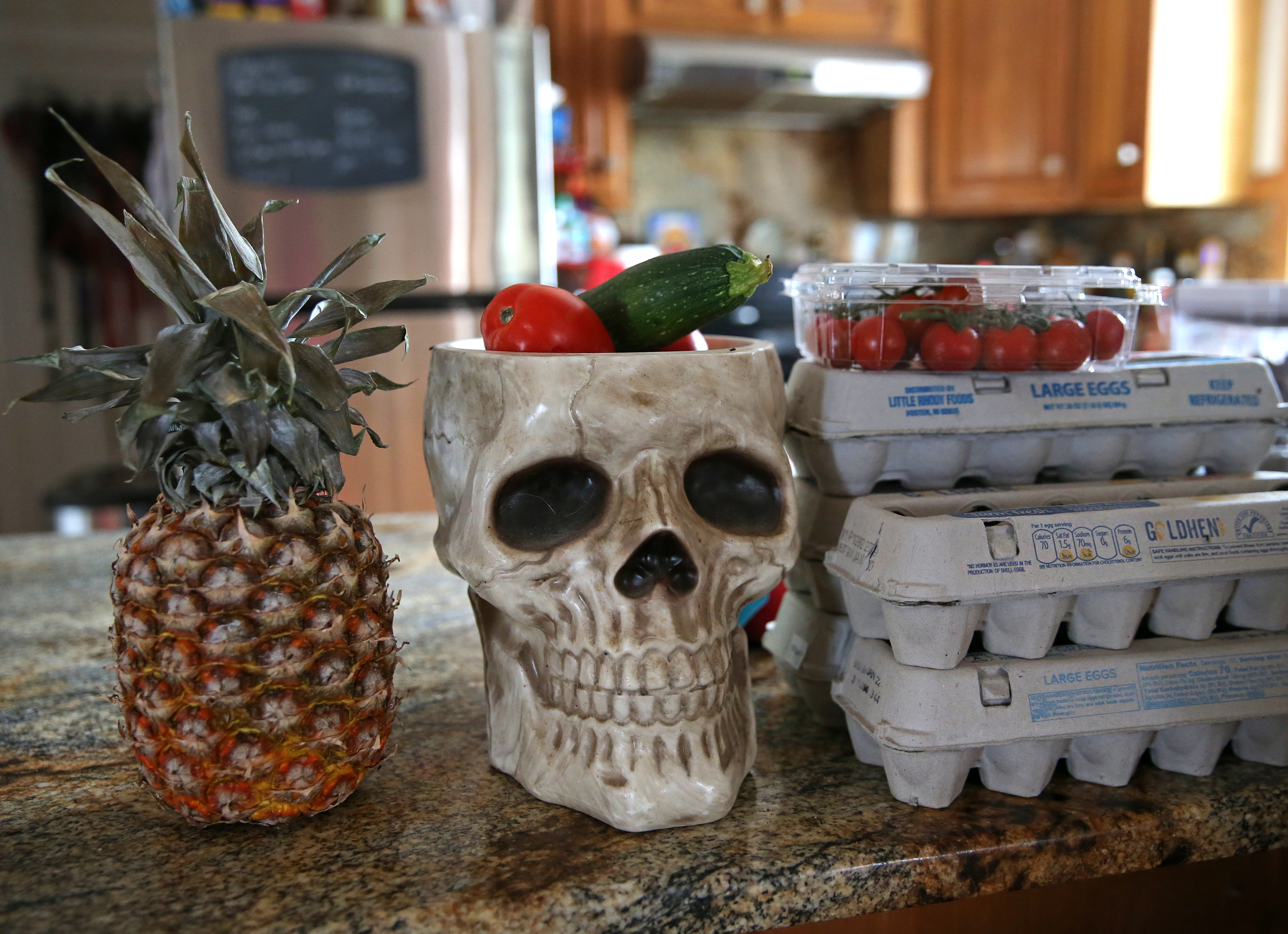 A glass skull holds vegetables in the kitchen of Dr. Priya Banerjee's home.