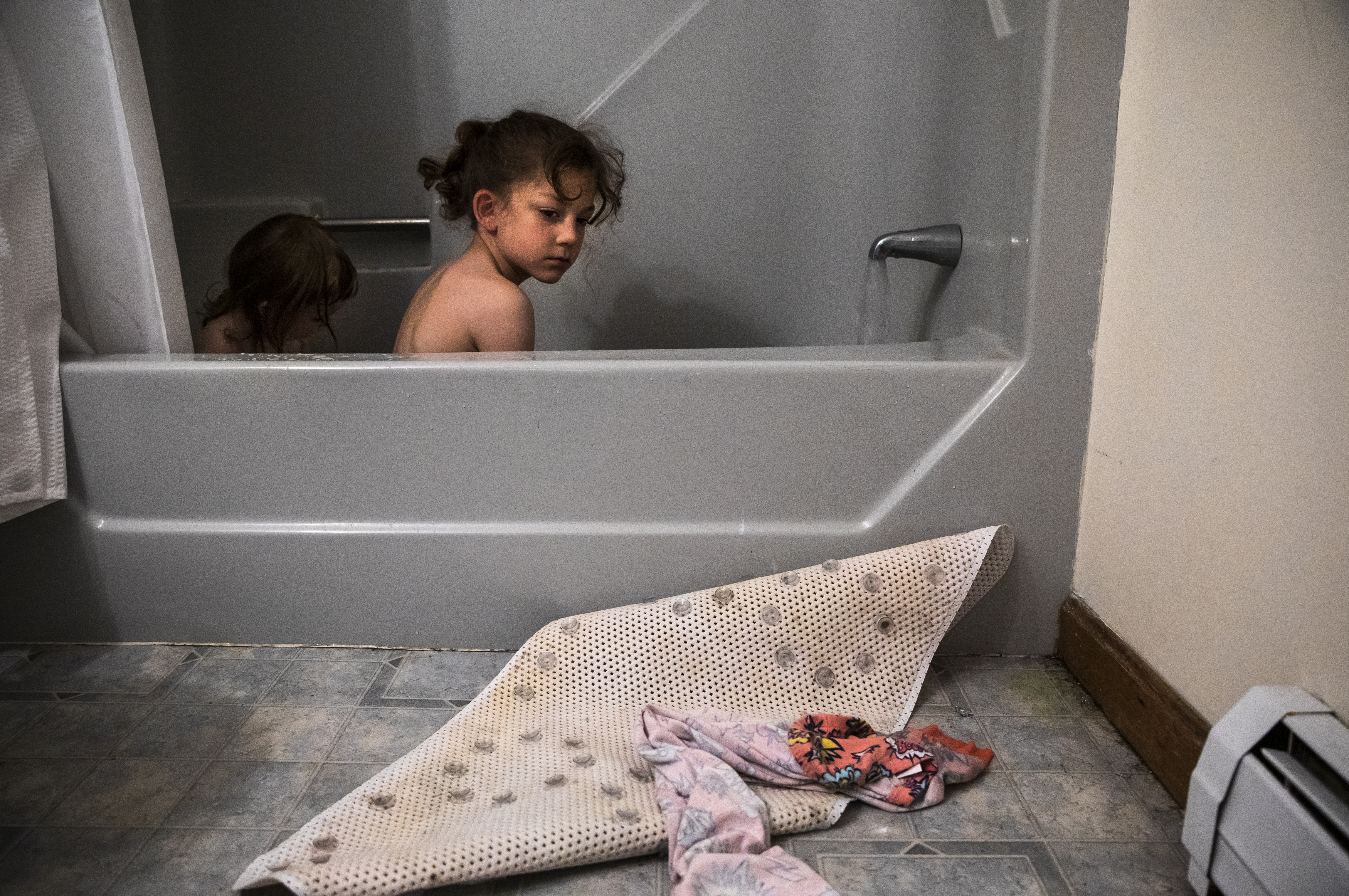 Laya and Evan Lupien take a bath while their parents pack to move out of their three-bedroom apartment after being evicted in Biddeford, Maine. Evan, who has severe ADHD and cognitive issues, was not receiving the one-on-one attention that he needed while living in northern Maine. Oftentimes, he would be placed by himself in a resource room because the school did not know what to do with him.