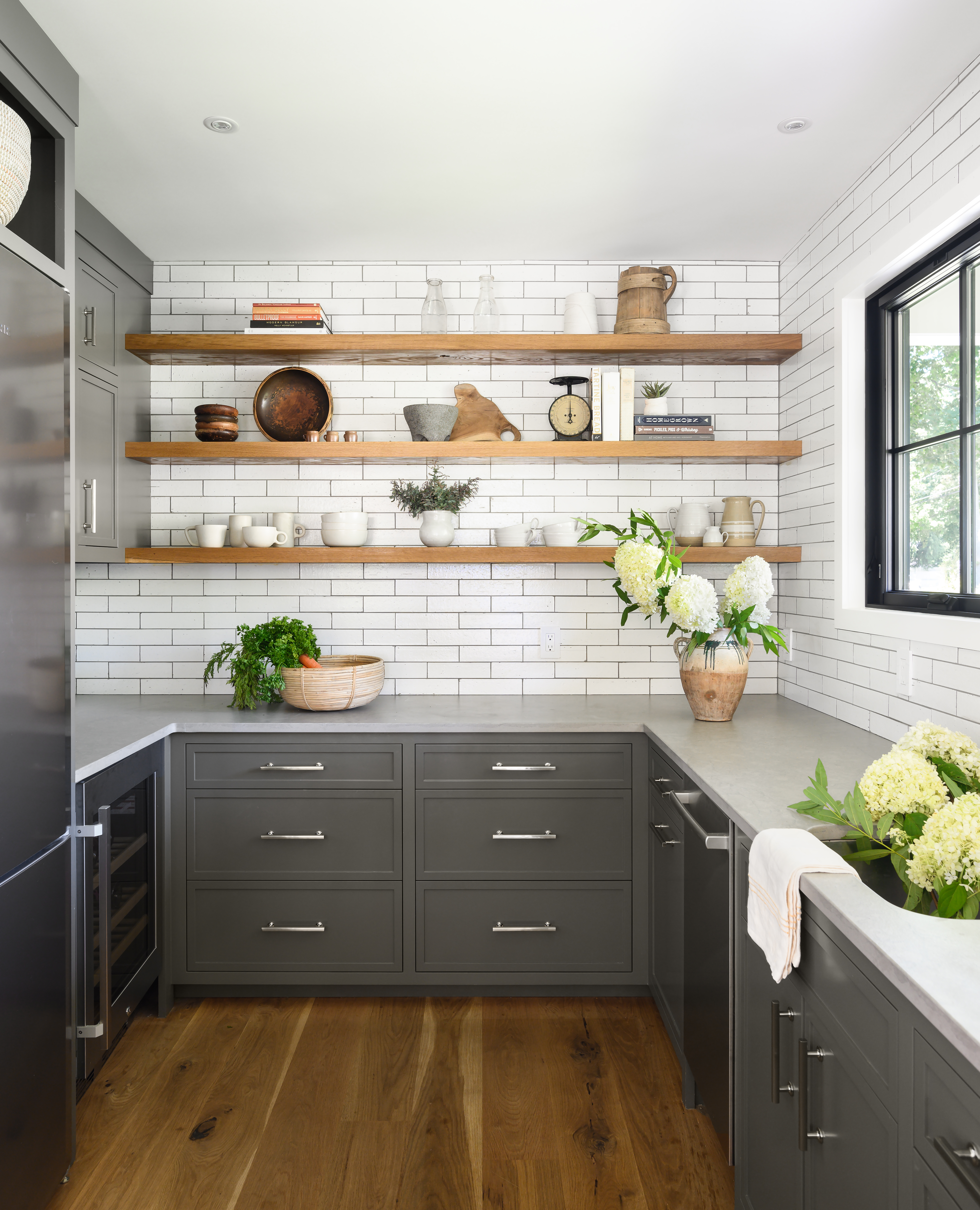 The pantry is accessible from the kitchen as well as from the deck, which wraps that end of the house.