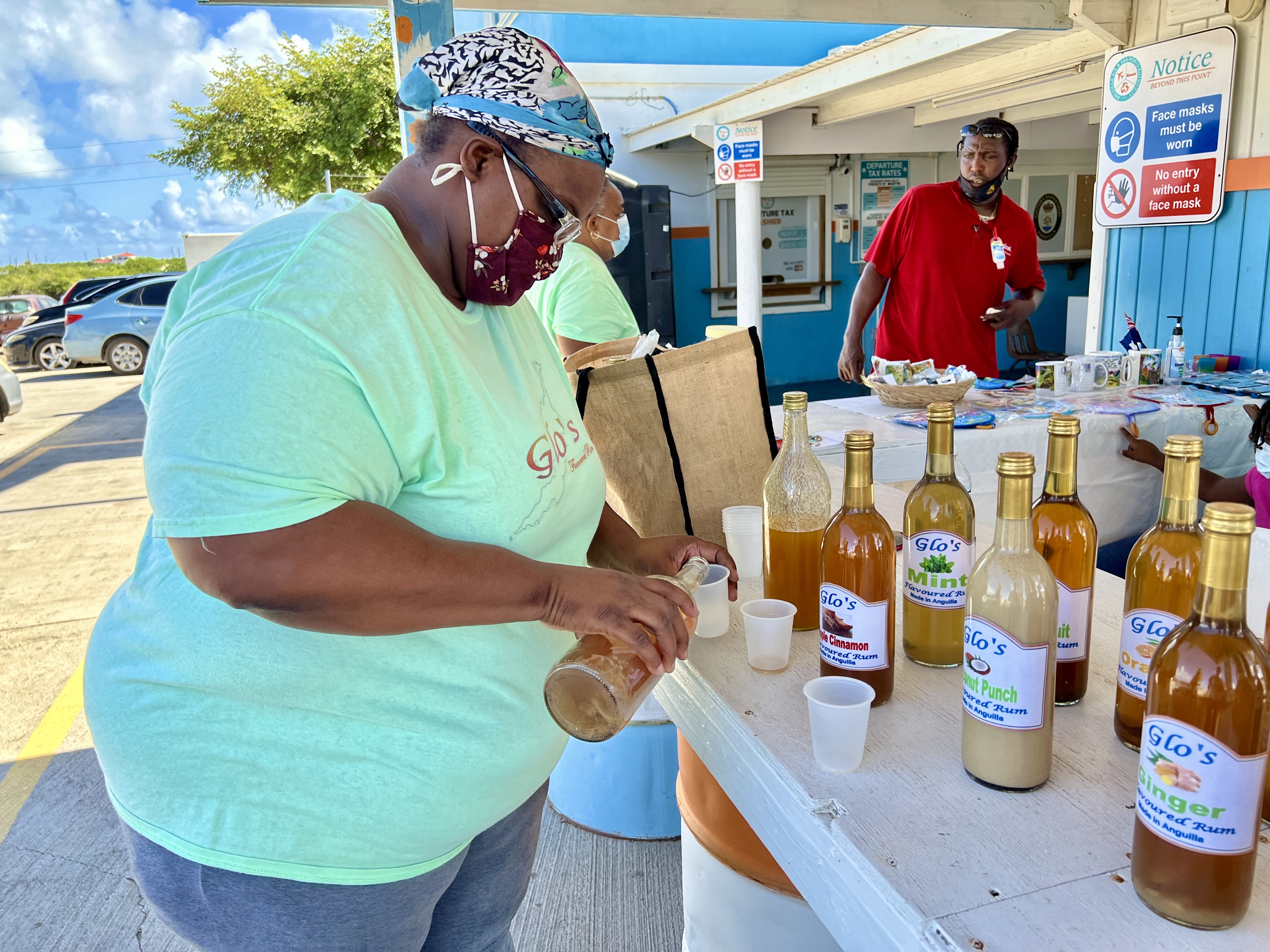 Julianne Leveret sets up an impromptu rum tasting outside passport control in Anguilla. 