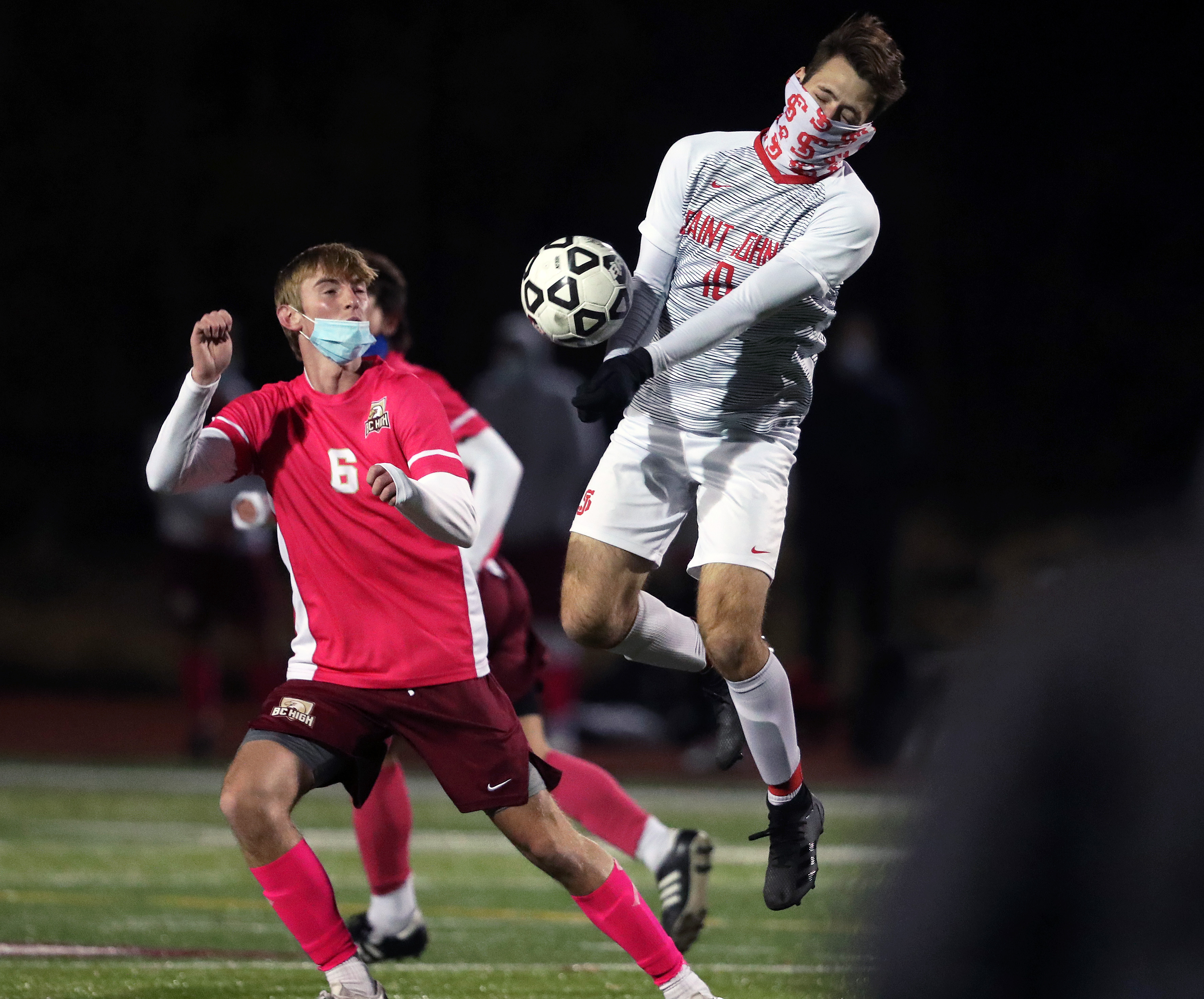 BC High's Matt Byrne (left) and St. John's Thalles Albino (right) battle for the ball in Wednesday night's Catholic Conference soccer championship.